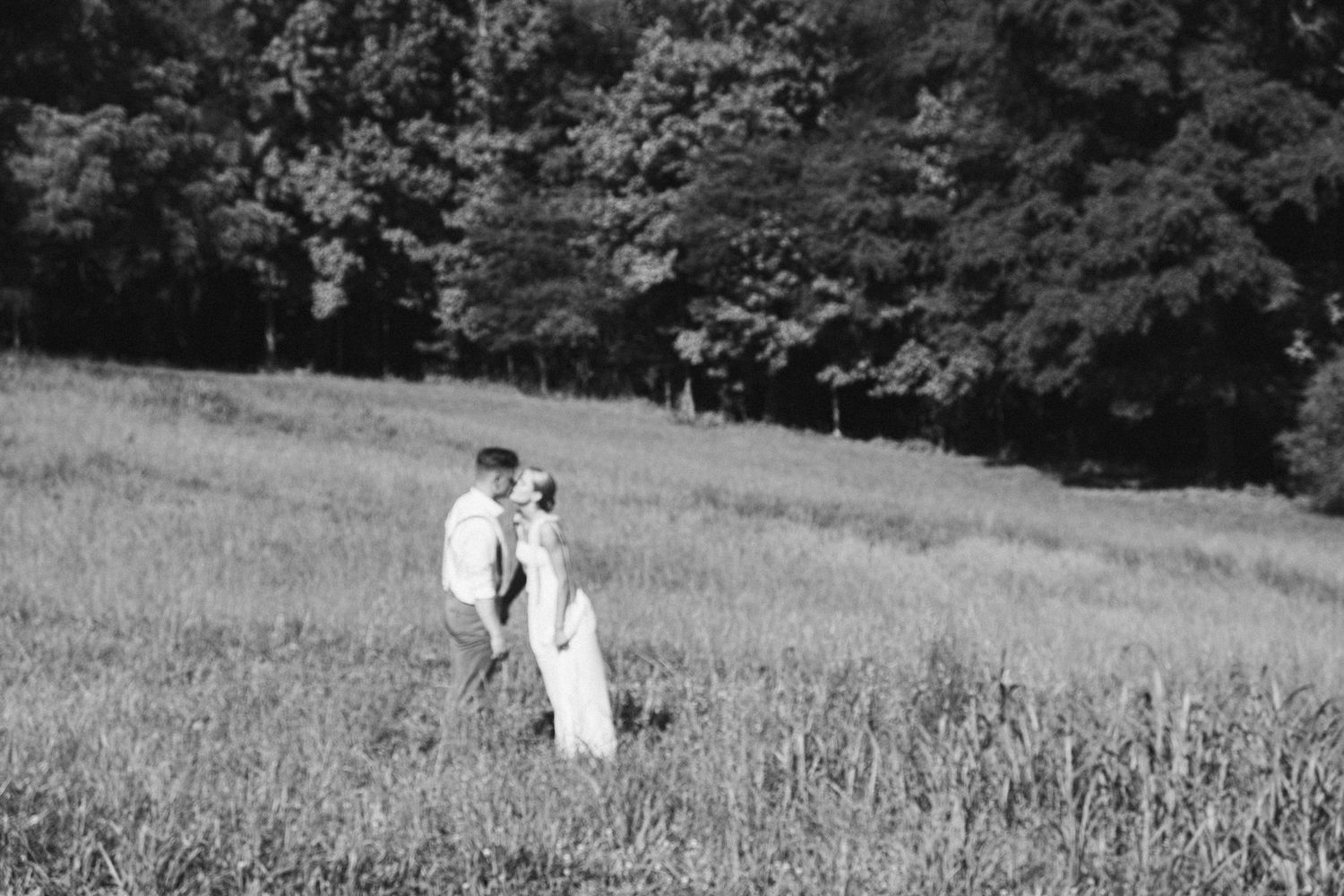 A grassy outdoor field with trees in the background shown in a sequence of black and white photos.