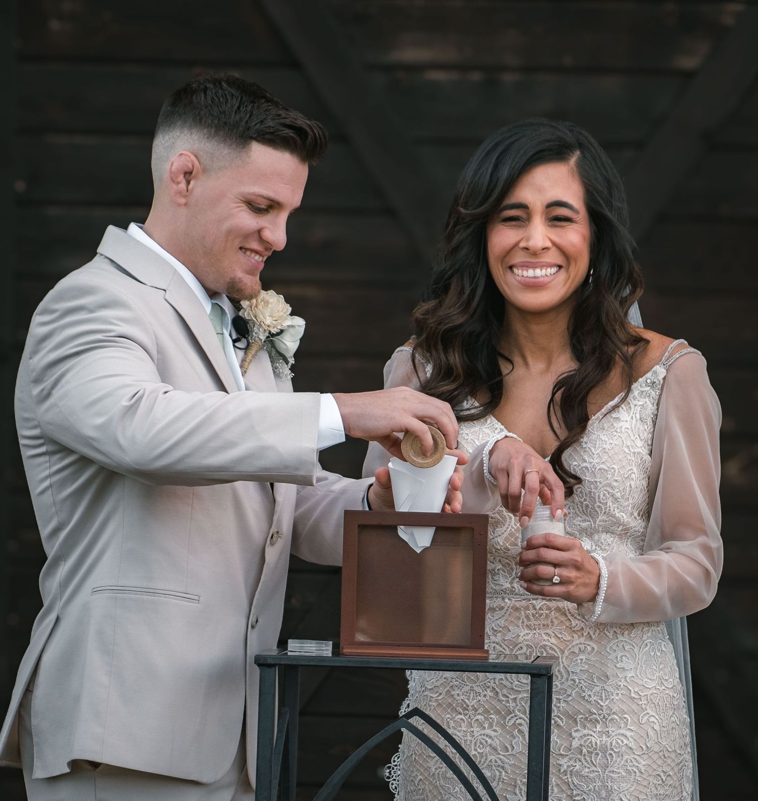 Wedding couple sharing a celebratory drink together.