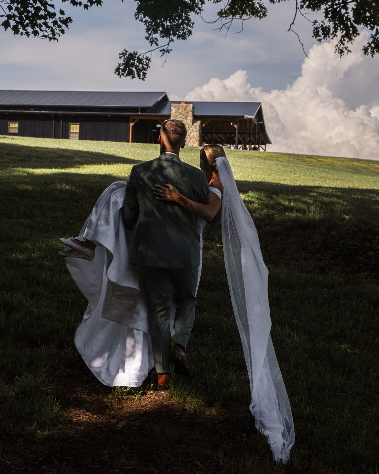Wedding dress flowing in the wind against a scenic outdoor backdrop.