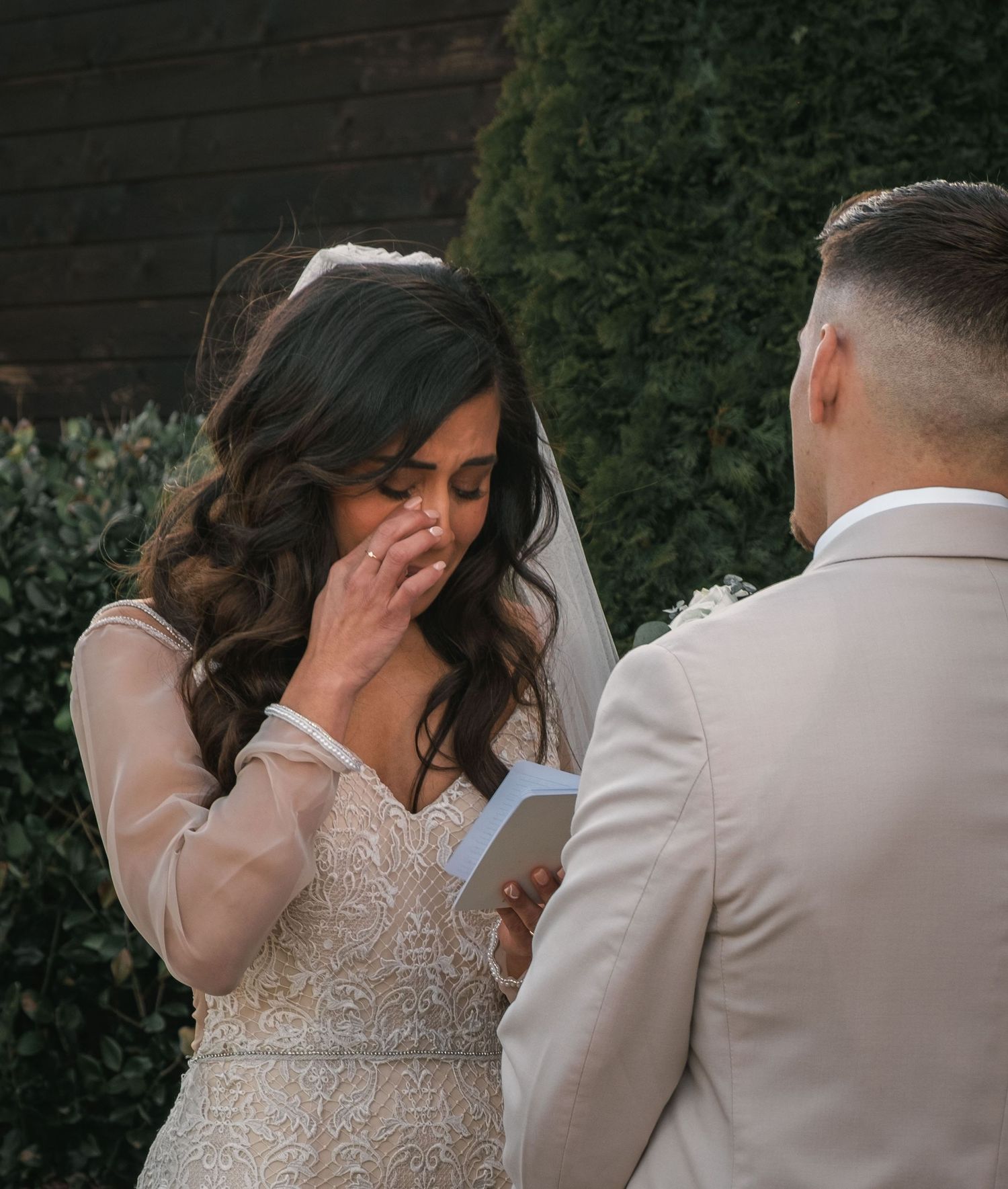 Tender wedding moment captured during an intimate outdoor ceremony.