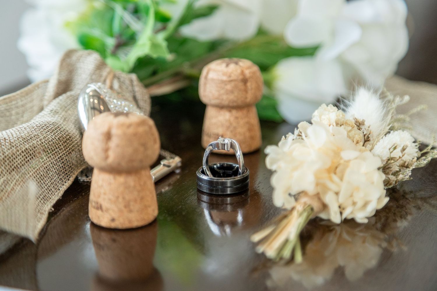 Elegant wedding details featuring rings and flowers, carefully arranged to capture the romance of a beautifully planned event.