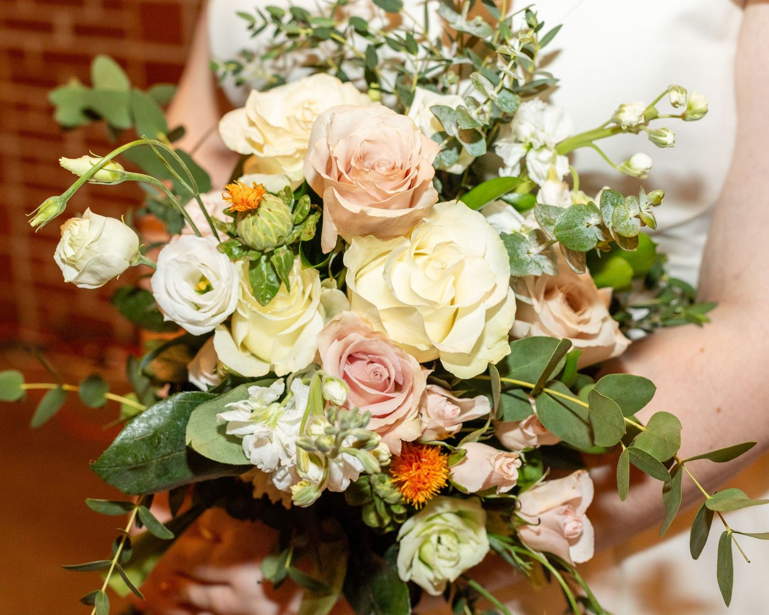 Elegant pink and white rose bouquet, perfect for weddings and special events, arranged with lush greenery for a timeless and romantic touch.