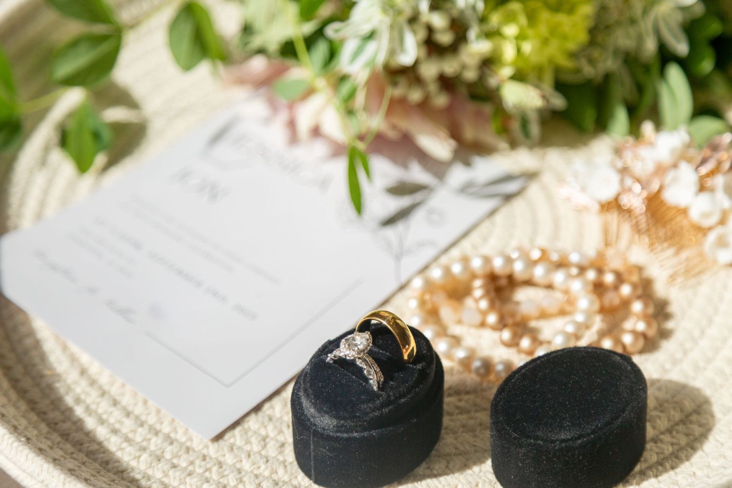 Elegant wedding details featuring rings and flowers, carefully arranged to capture the romance of a beautifully planned event.