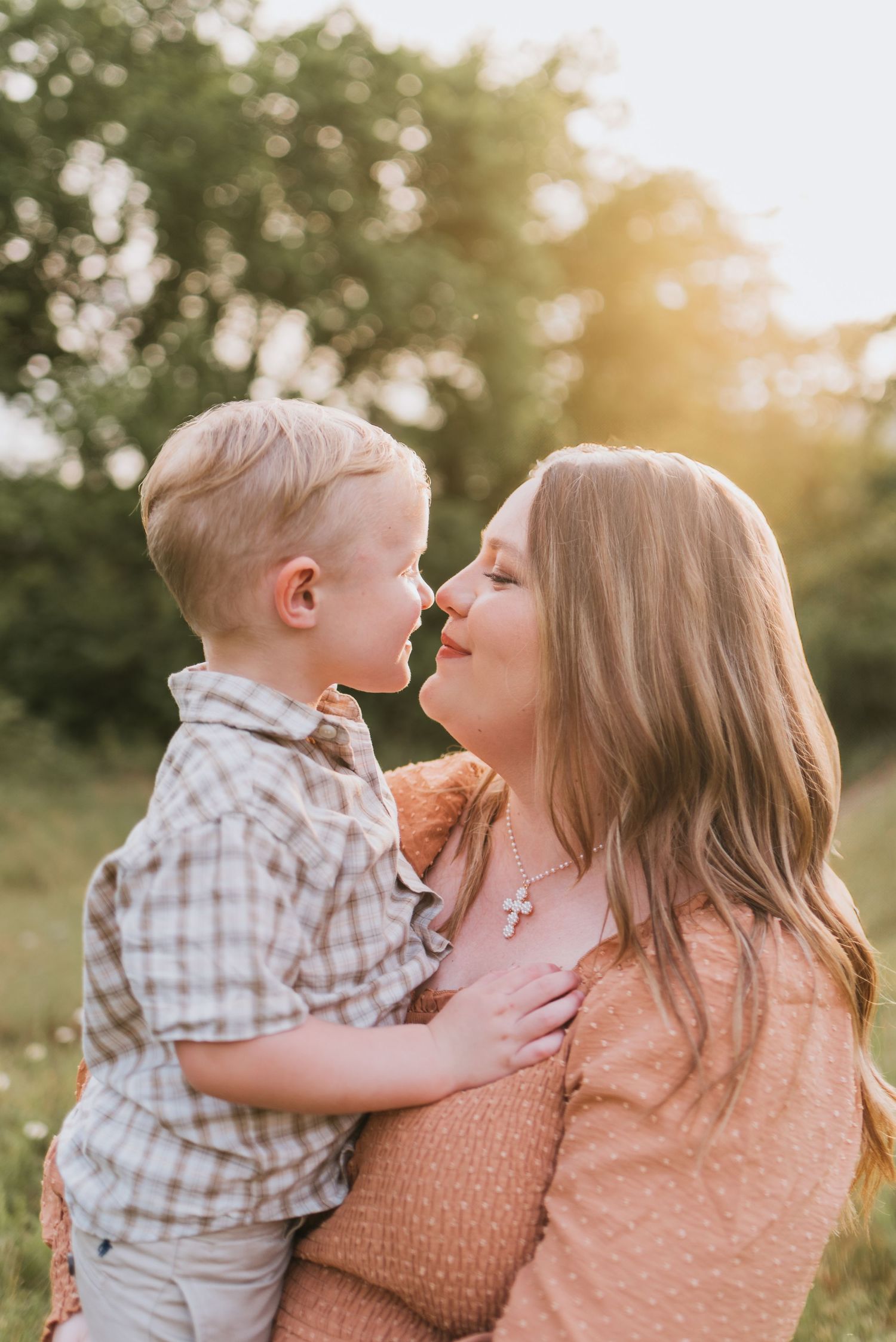 Mom holding toddler nose to nose in field, Chattanooga, TN – family maternity session, soft summer light