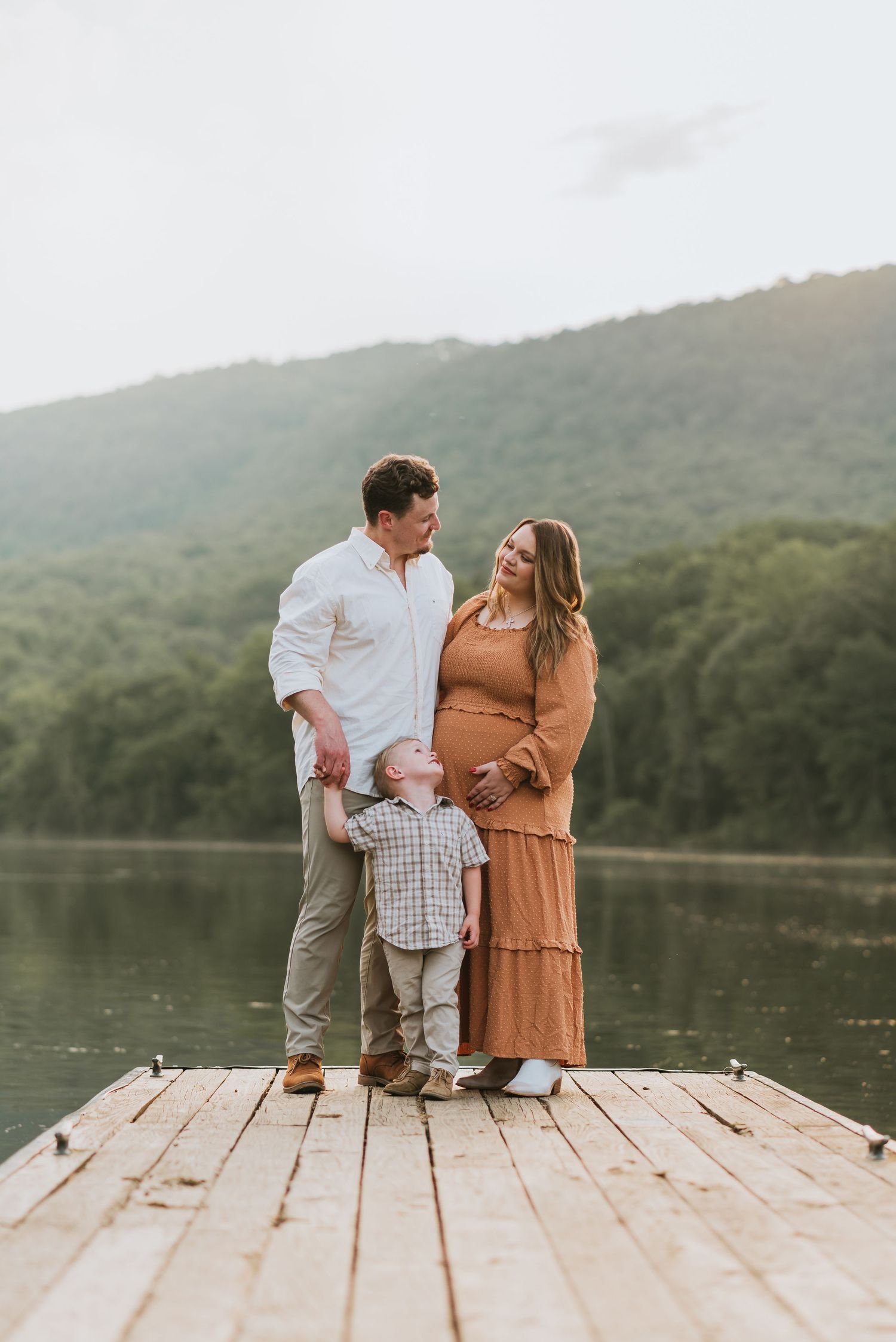 Family looking at mom on dock, Chattanooga, TN – family maternity session, soft summer light, mountains and water
