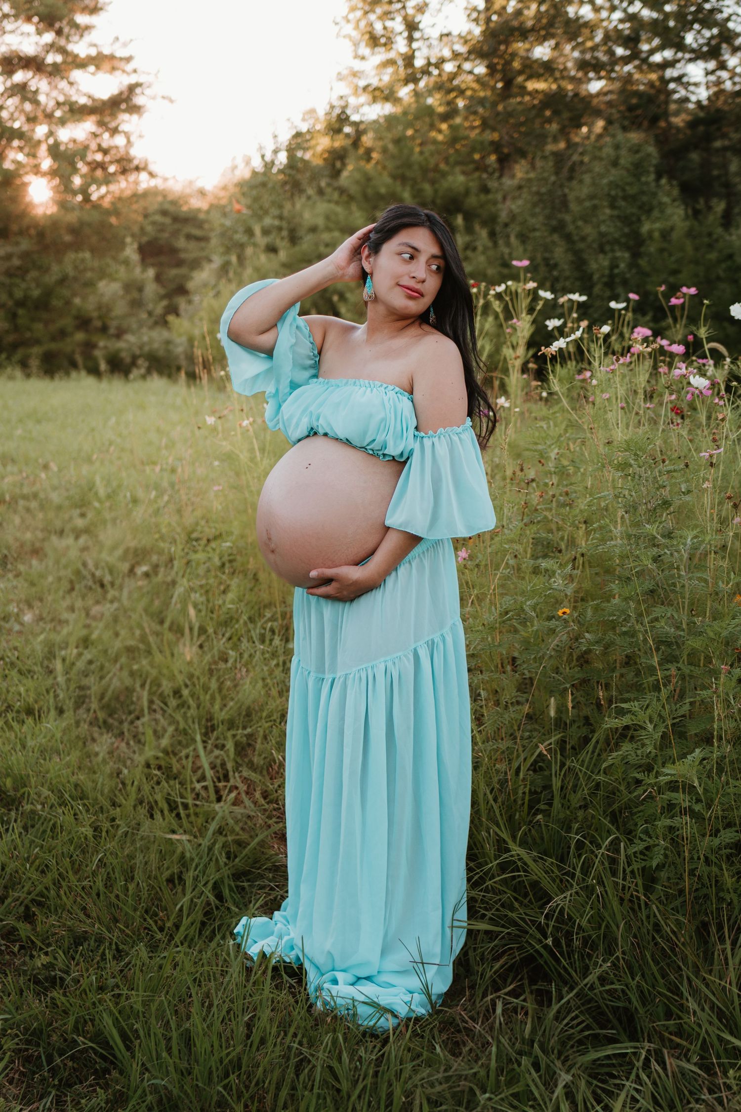 Itzayana playing with her hair a wildflower field at Fox Mountain Farms, Chattanooga, TN – maternity session, soft summer light