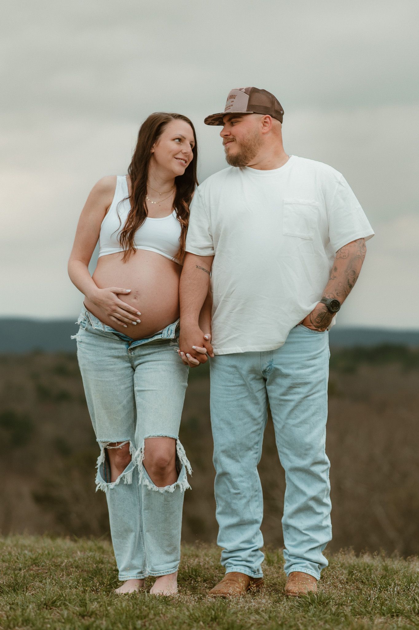 Expecting couple side by side holding hands during maternity session at raccoon mountain chattanooga TN, mountain overlook