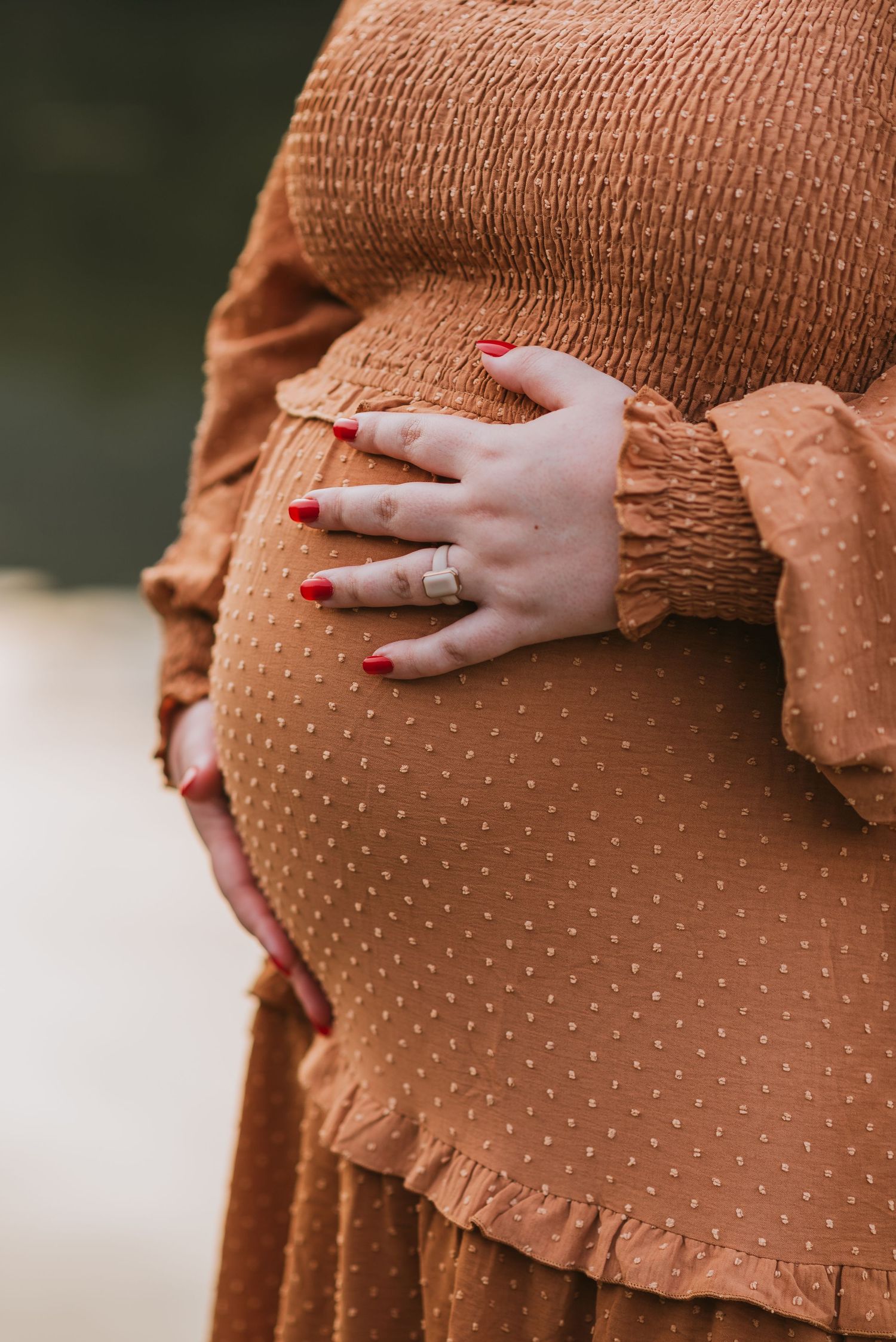 Close up of pregnant belly with water in background, Chattanooga, TN – family maternity session, soft summer light