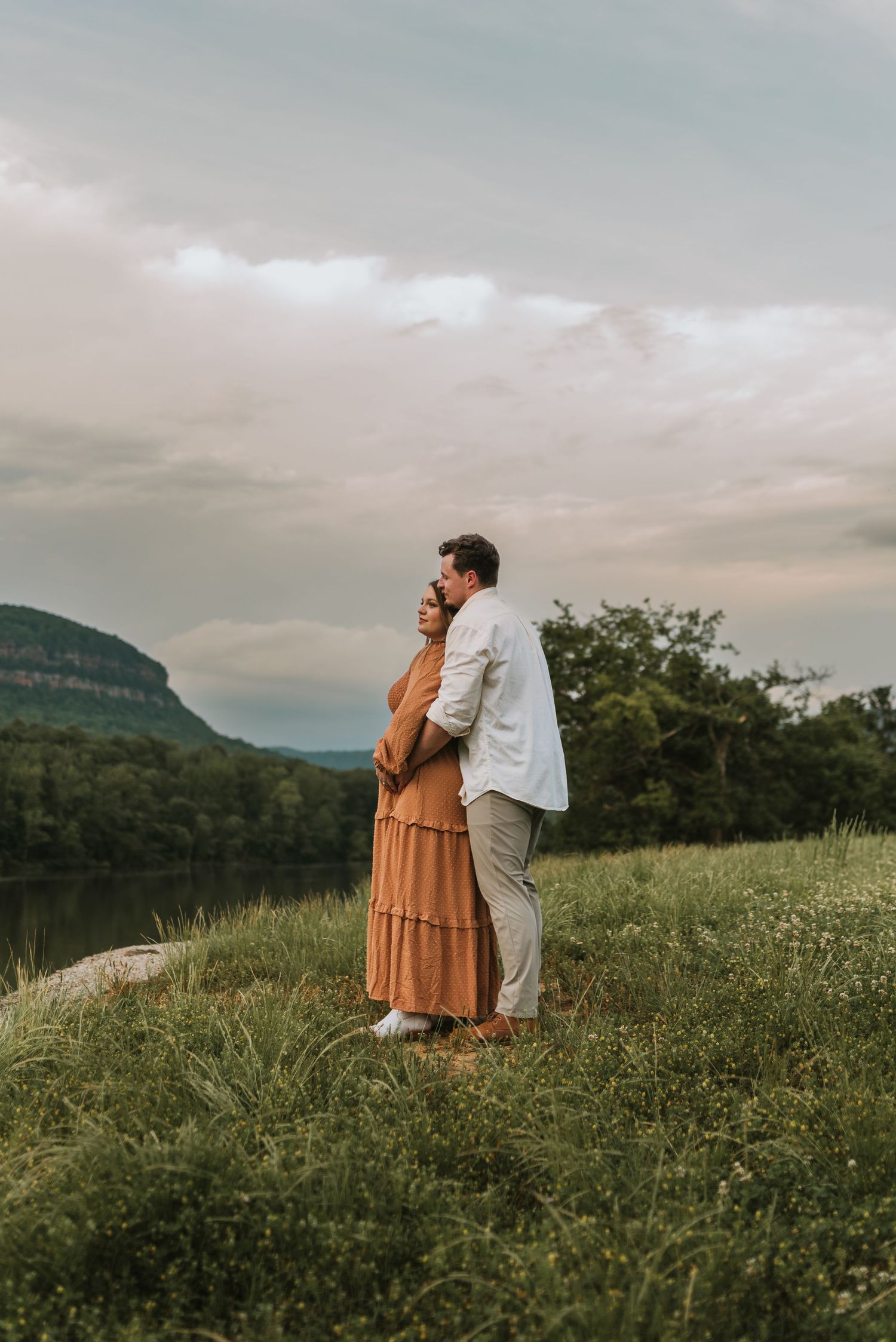 Couple looking out towards mountains and water  in Chattanooga, TN – family maternity session, soft summer light
