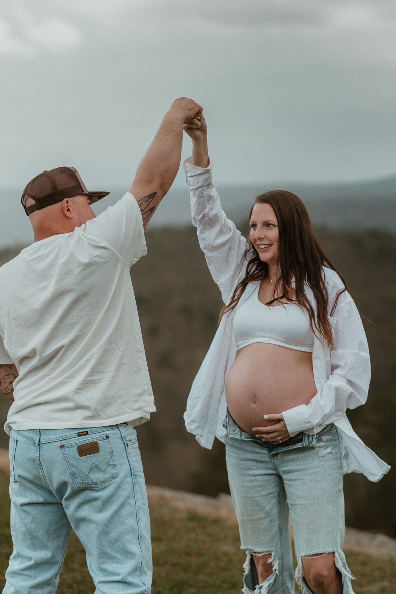 Expecting couple dancing and spinning during maternity session on raccoon mountain in chattanooga tn, mountain overlook