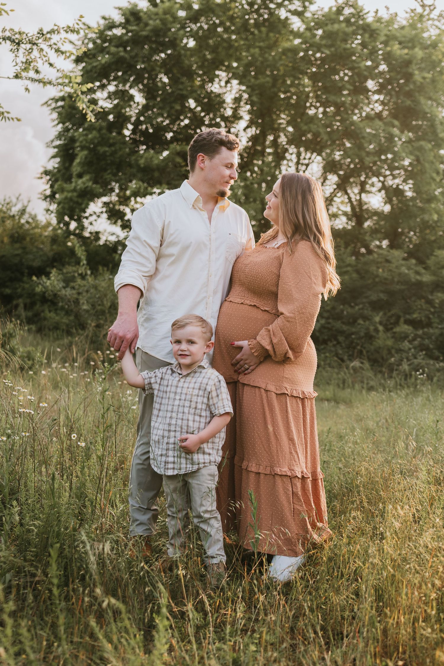 Family in field, parents looking at each other Chattanooga, TN – family maternity session, soft summer light