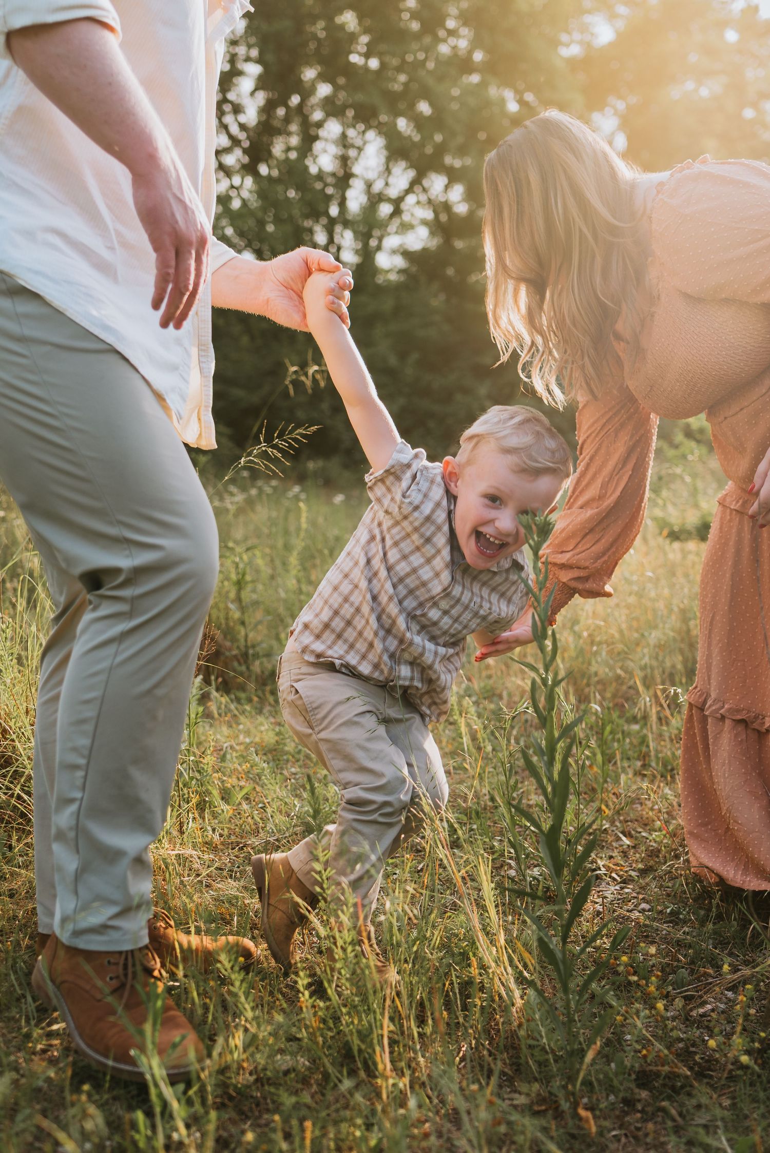 Family playing in a field in Chattanooga, TN – family maternity session, soft summer light