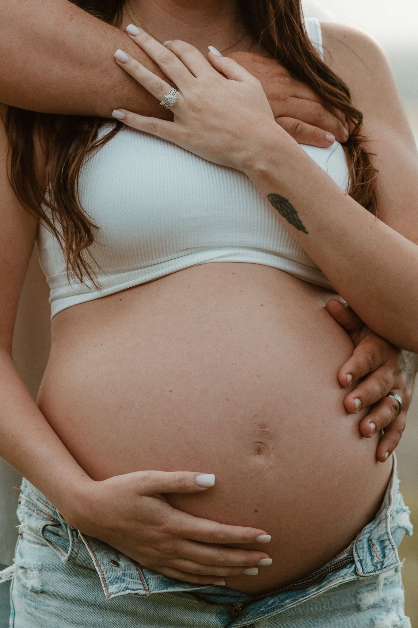 Close up of expecting couple with him standing behind her holding her and bump during maternity session on raccoon mountain chattanooga TN
