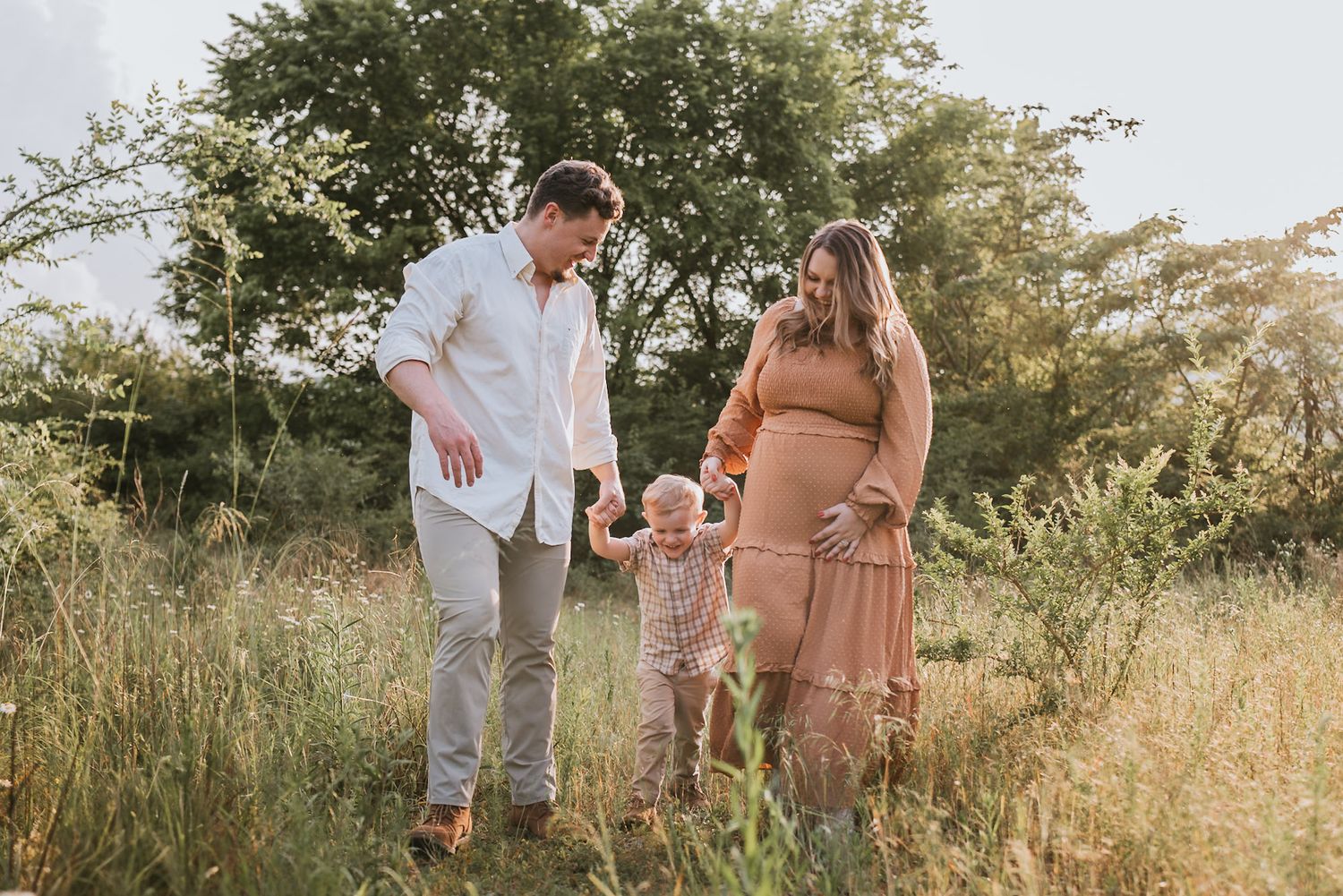 Family in field walking during golden hour family maternity session raccoon mountain Chattanooga TN