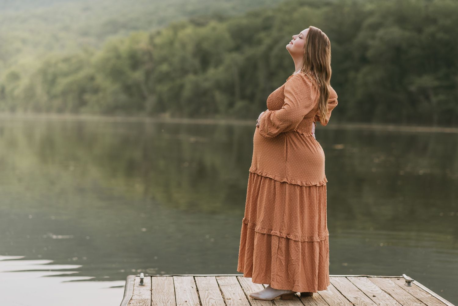 Dallas holding belly looking up with water in background, Chattanooga, TN – family maternity session, soft summer light