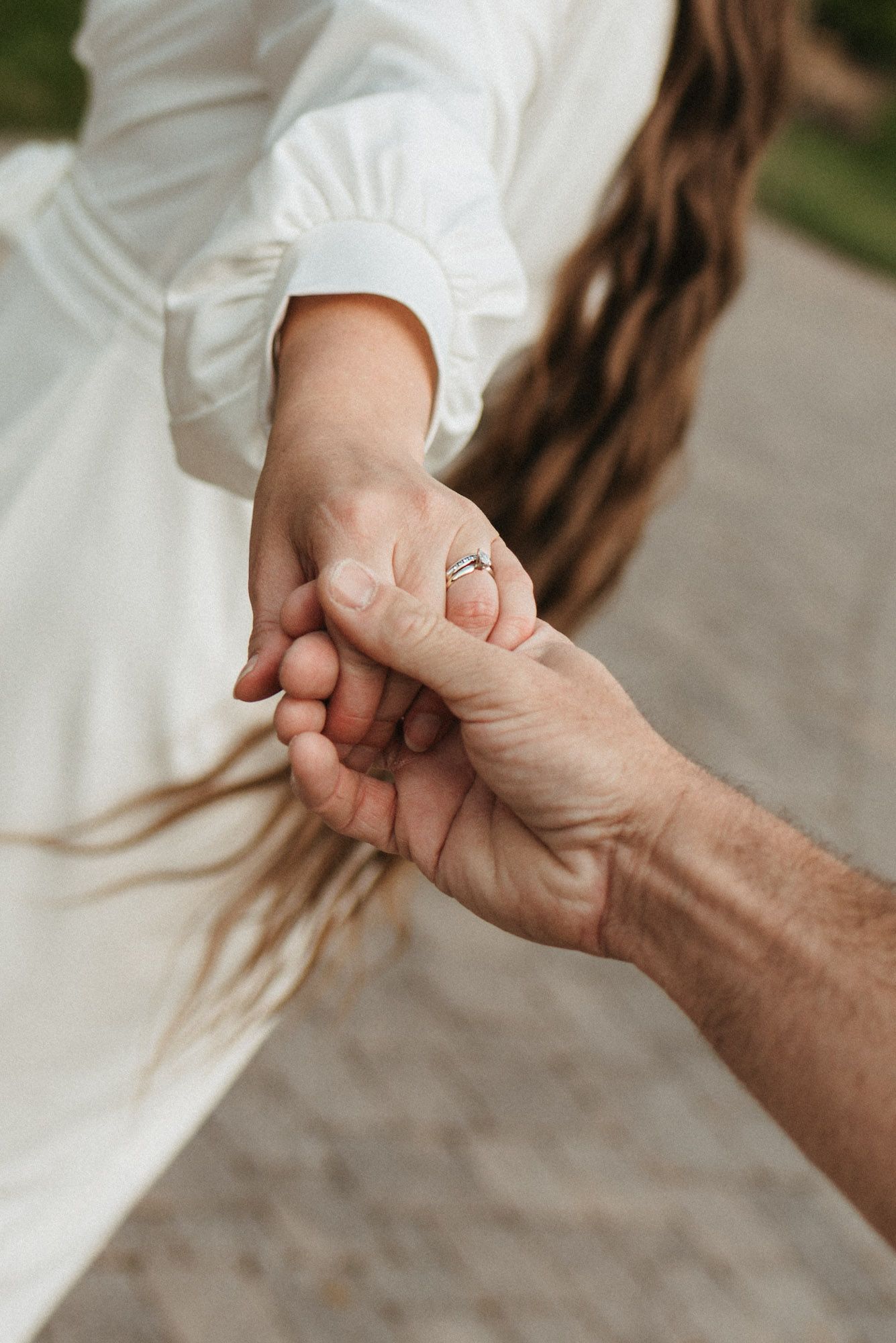 Close up of wedding ring and couple holding hands outdoors during a romantic session on Lookout Mountain, Georgia
