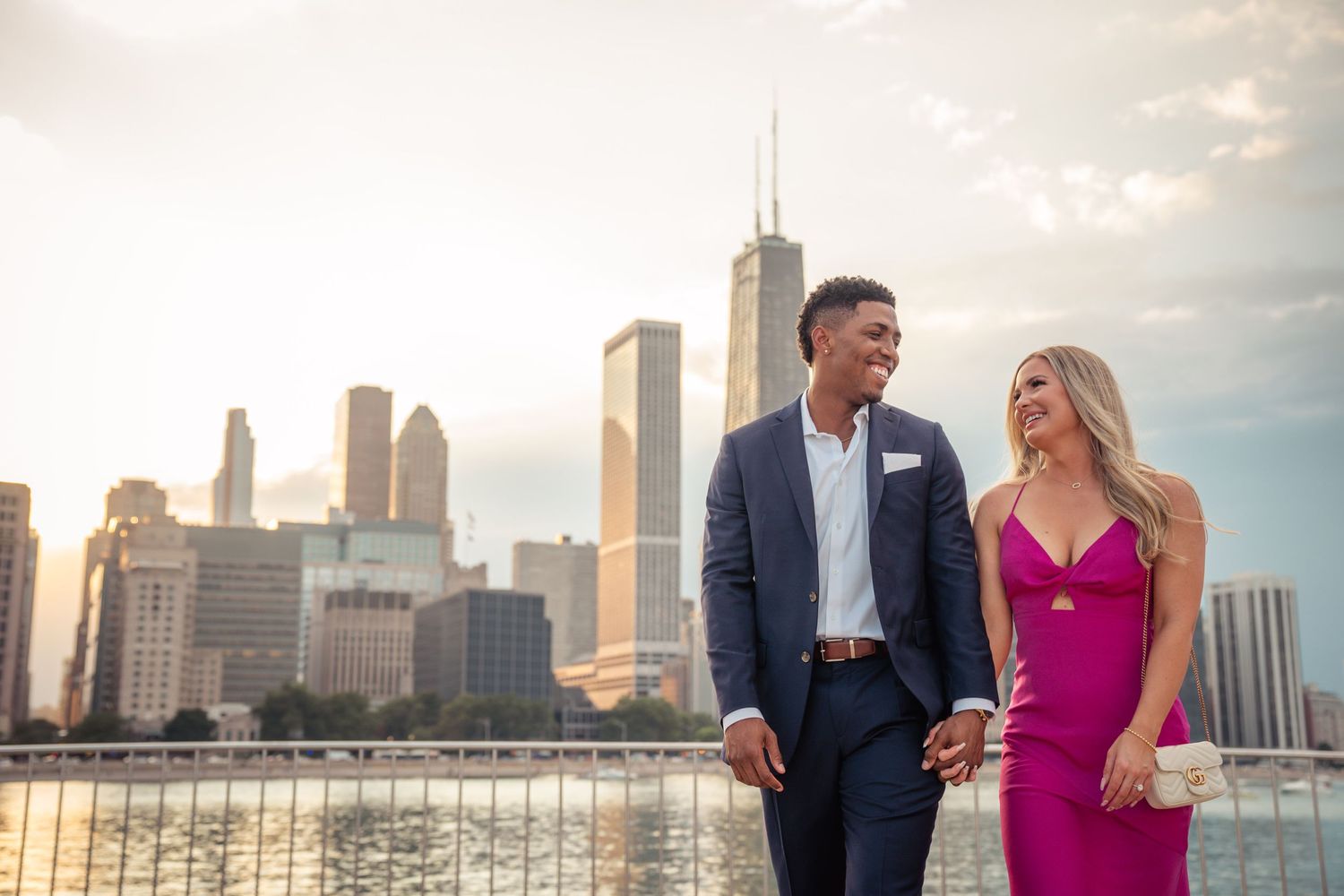 Happy couple enjoying romantic evening with Chicago skyline backdrop as sun sets over downtown.