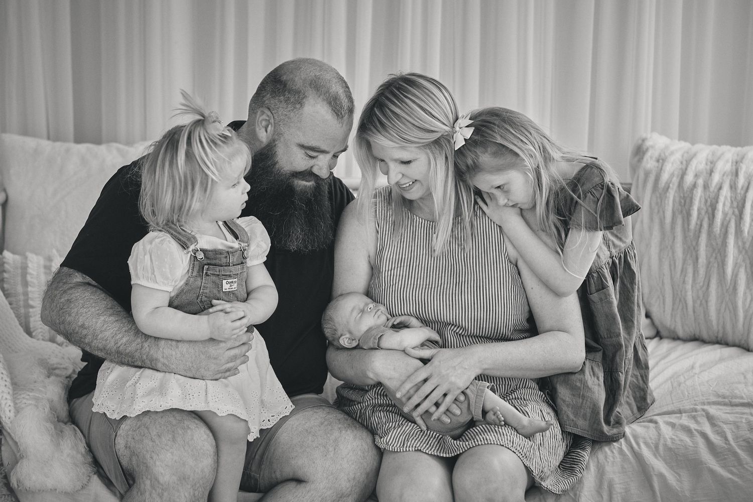 Four connected images showing tender moments between parents and children relaxing together on a couch.