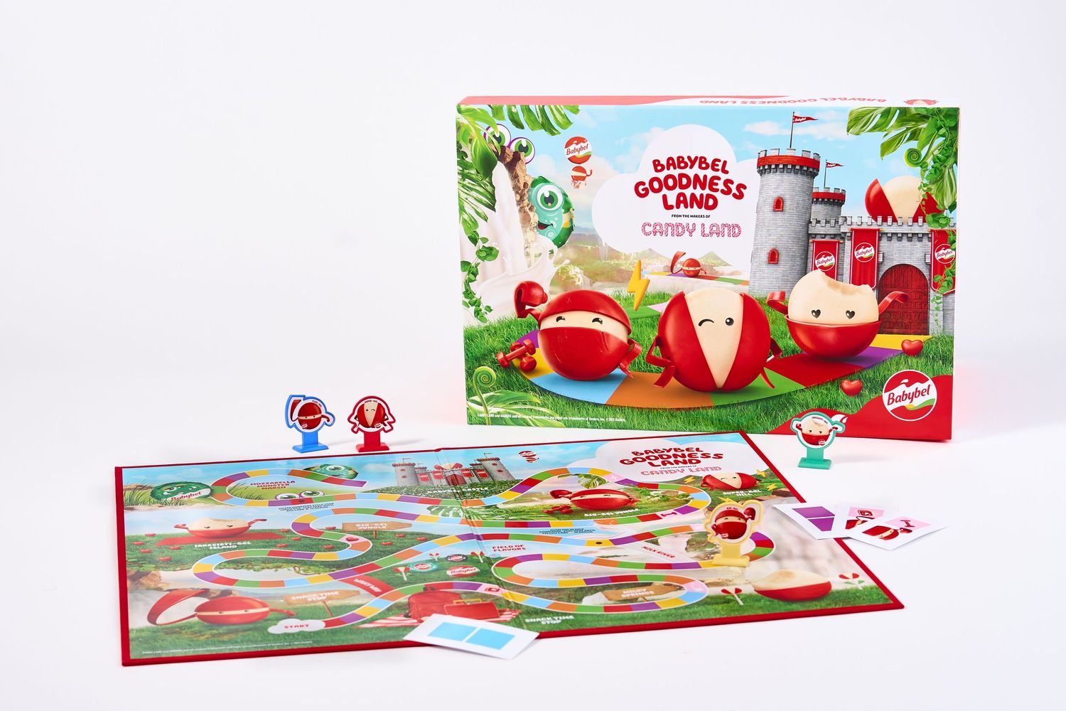 Colorful board game setup with red game pieces and festive holiday-themed artwork.