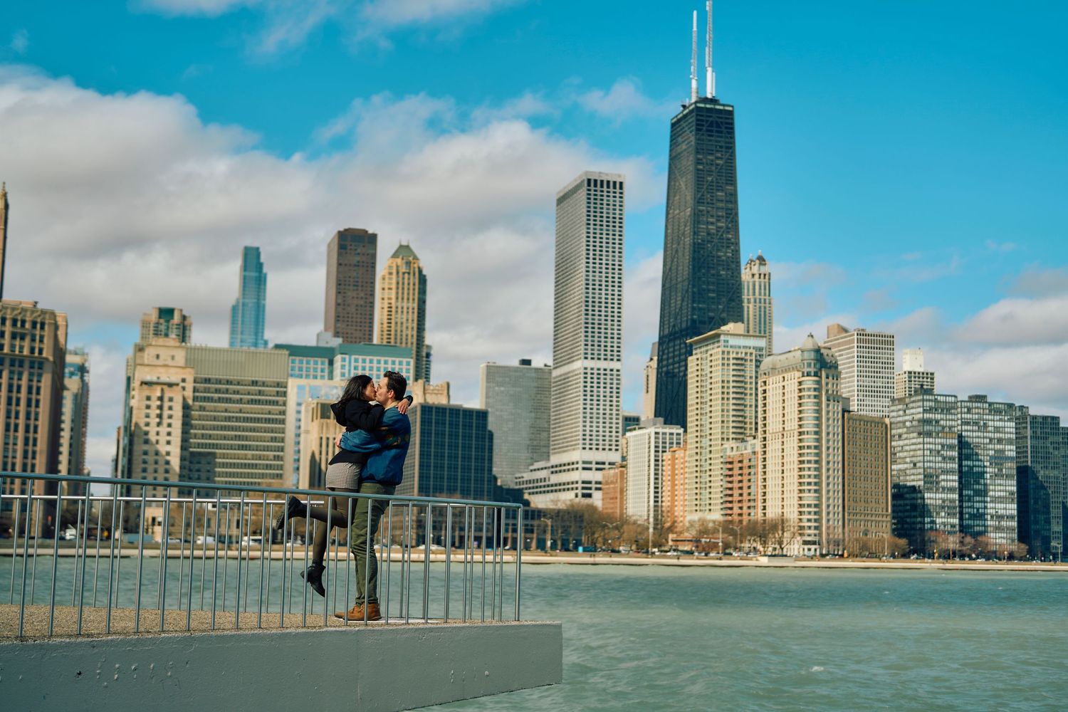 Chicago skyline and Lake Michigan waterfront view with figure silhouetted against blue sky and iconic skyscrapers.