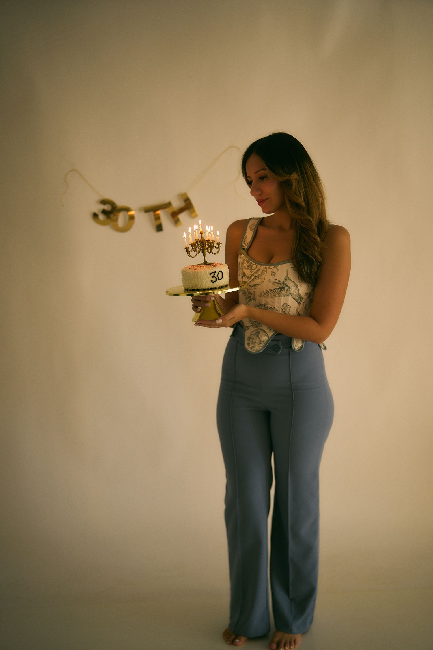 Warm-toned portrait with birthday cake and decorative elements.