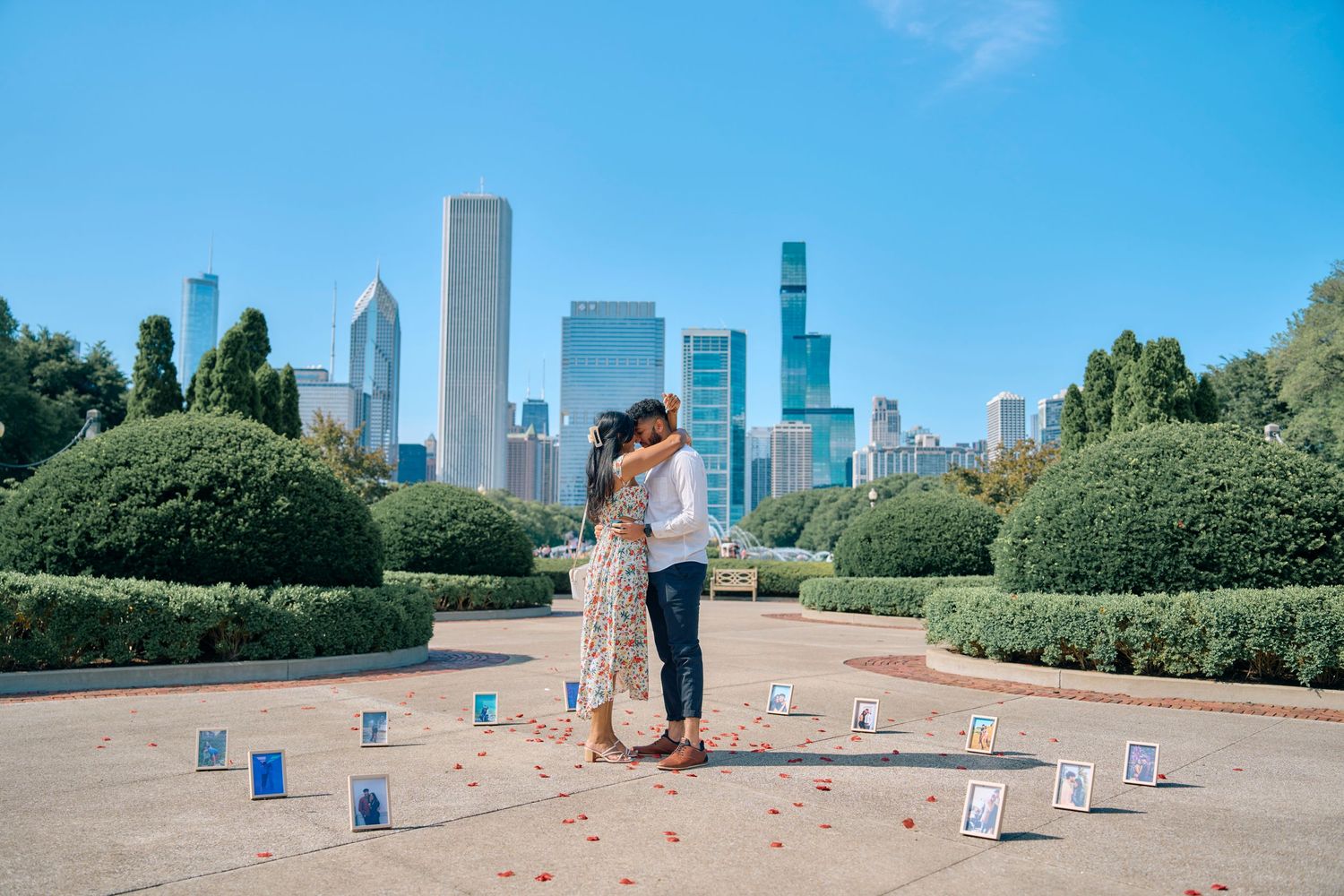 A couple shares a romantic moment in Grant Park with the Chicago skyline and scattered LED tea lights in the background.