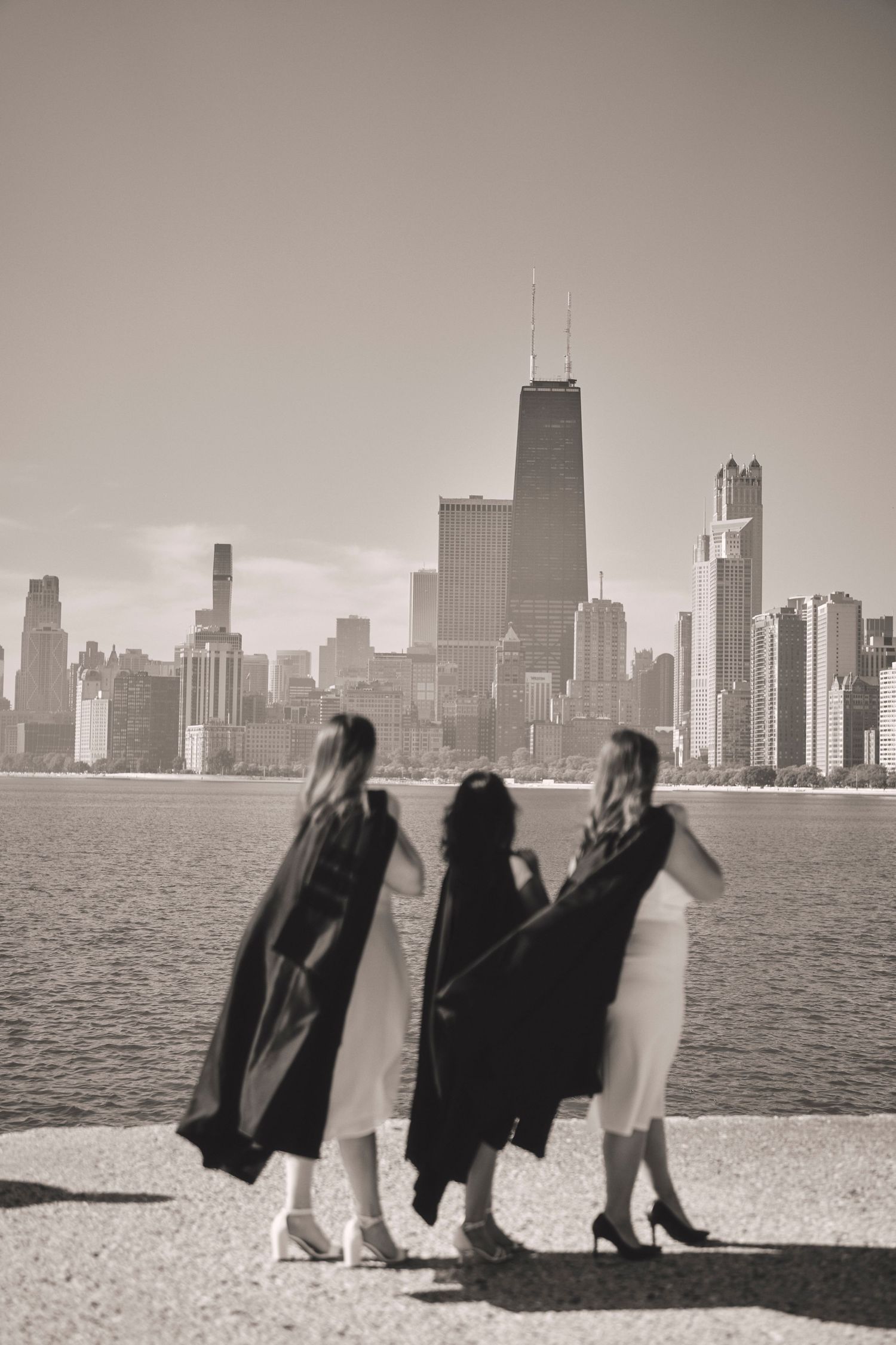 A sequence of black and white photos showing silhouettes walking along Chicago's lakefront with the city skyline in background.