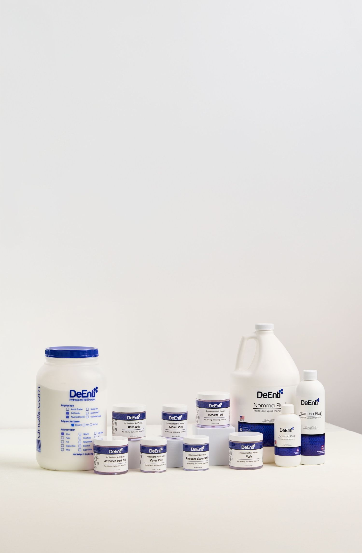 Professional arrangement of DeEnfi skincare products on clean white surface.