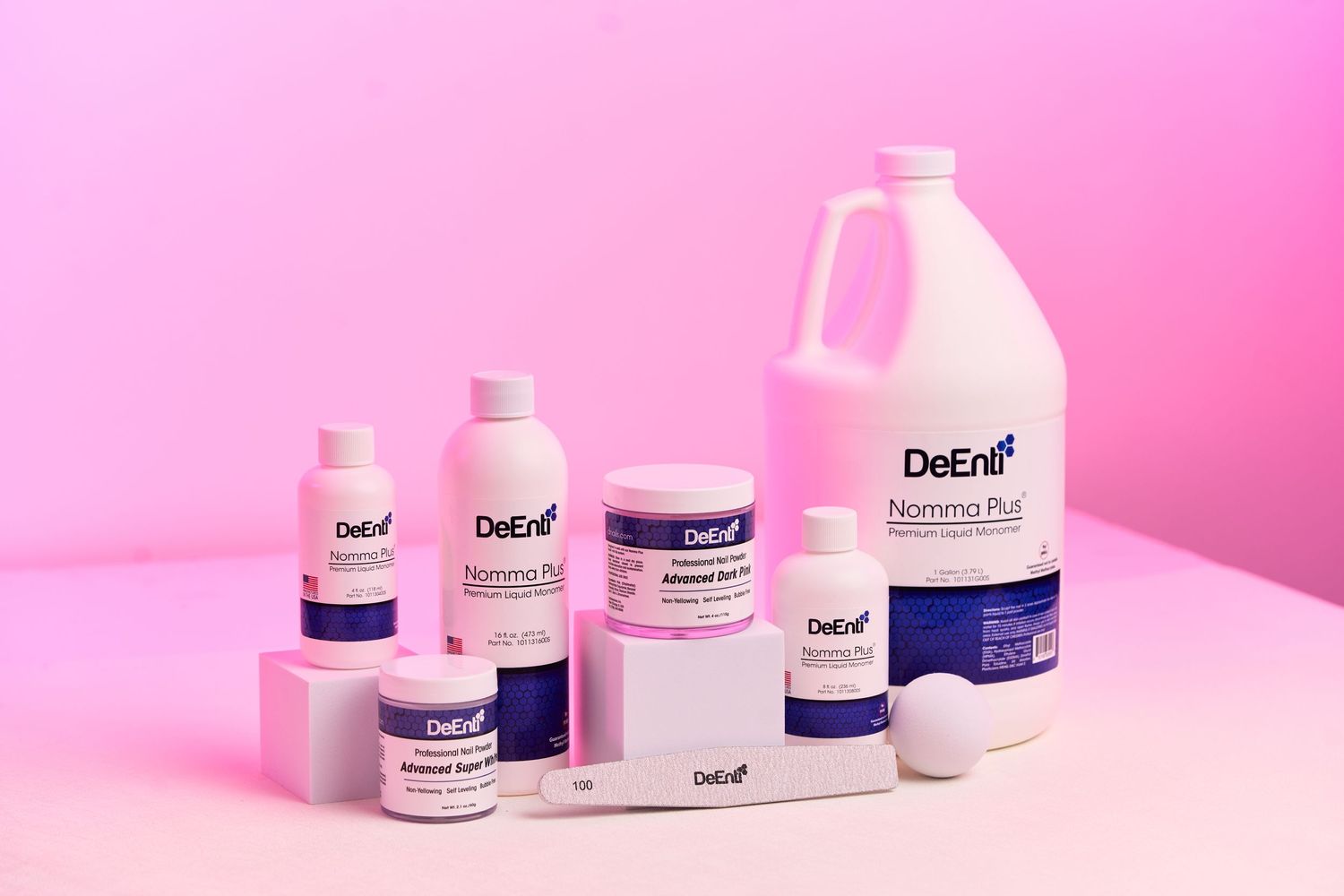 DeEnfi skincare product line displayed against pink background with various sized containers.