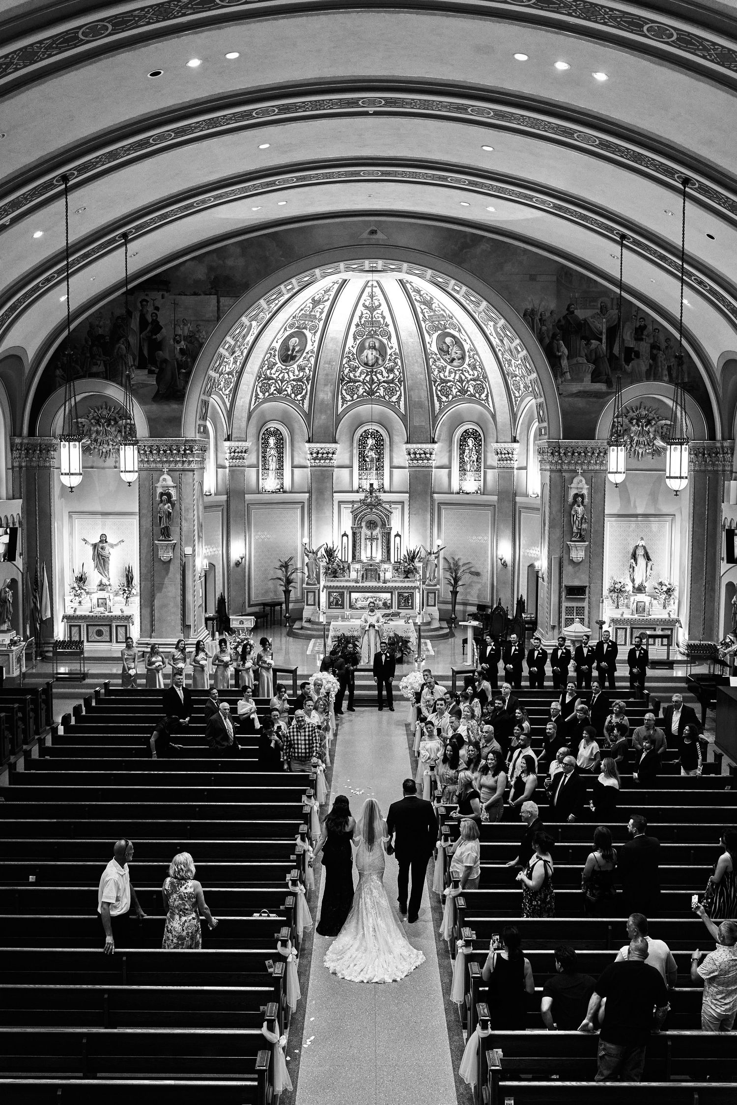 Panoramic sequence showing the progression of a traditional Catholic church wedding ceremony from multiple angles.
