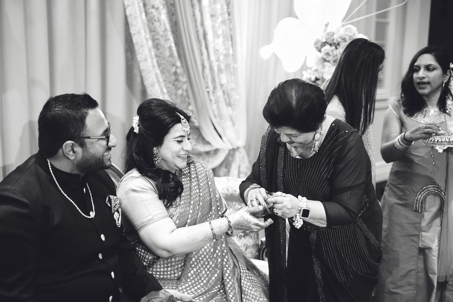 A black and white photo of people gathered around during what appears to be a traditional ceremony or ritual.