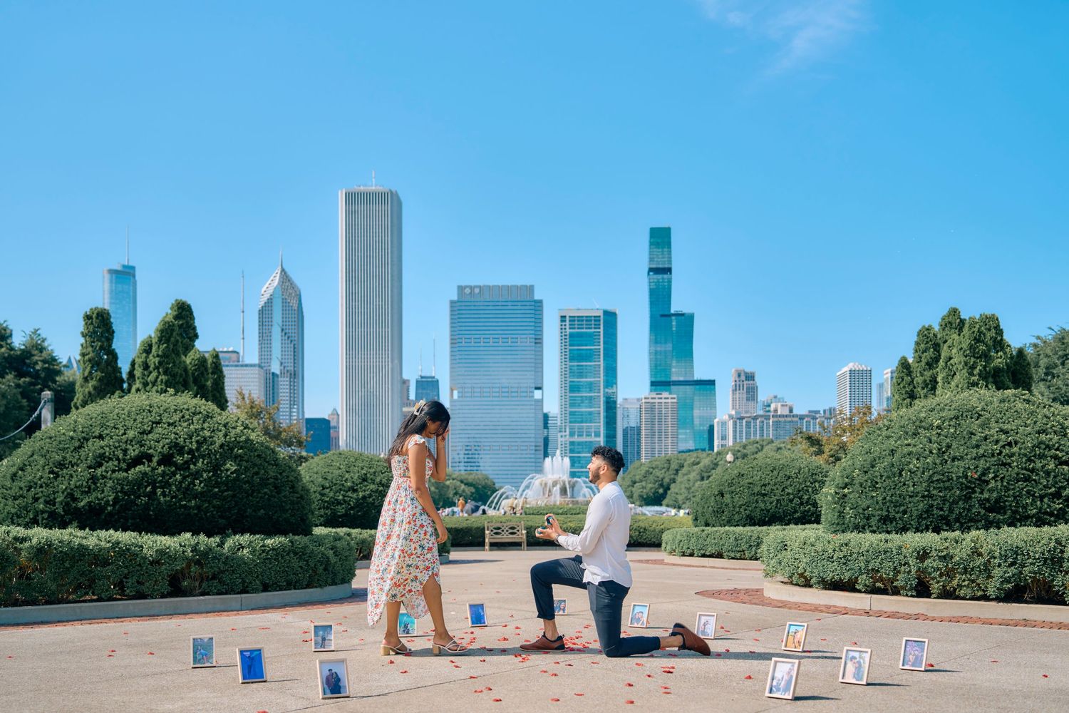 A proposal moment with candles and rose petals in Chicago's Grant Park with the iconic skyline in the background.