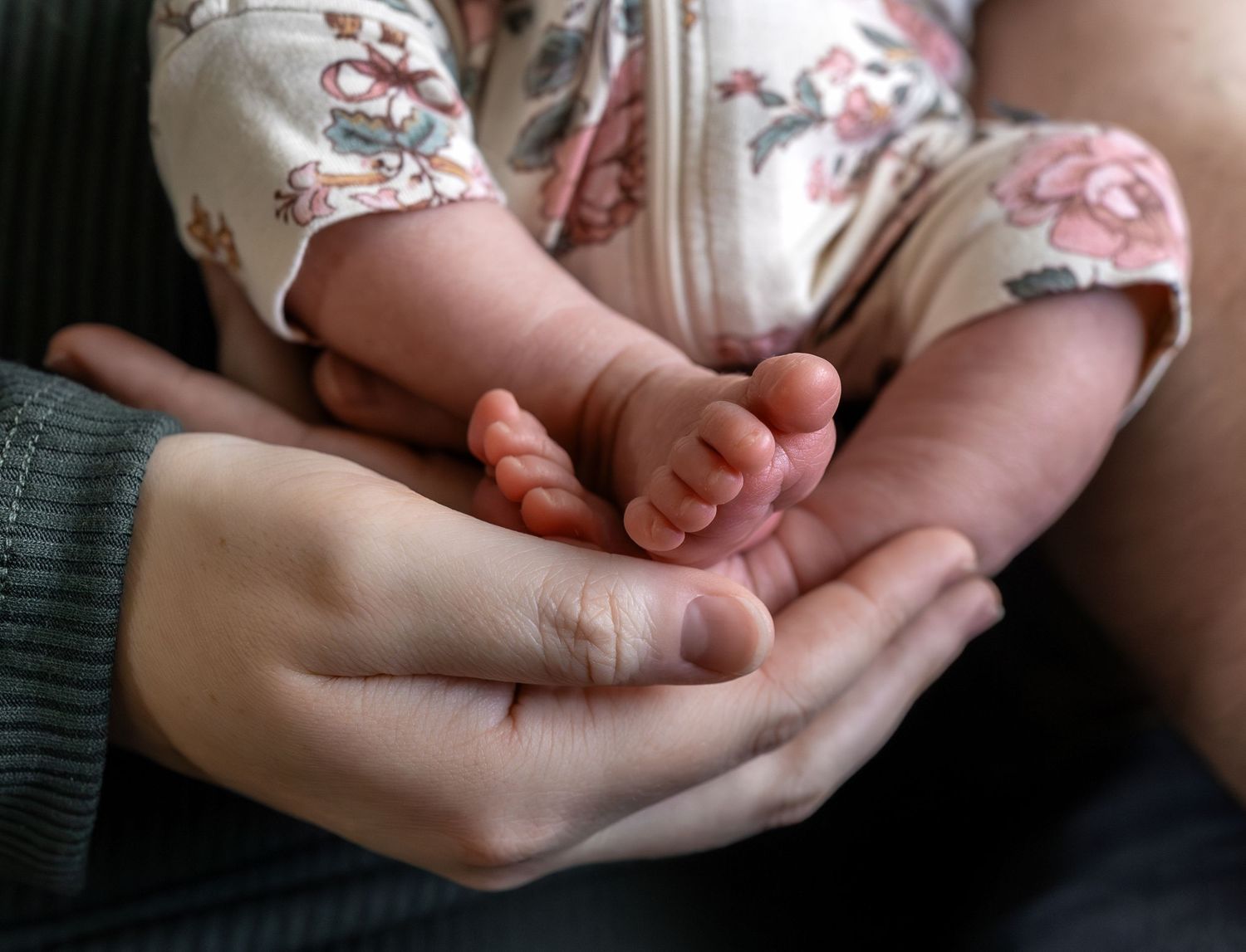 A close up image of a newborn baby girls toes.