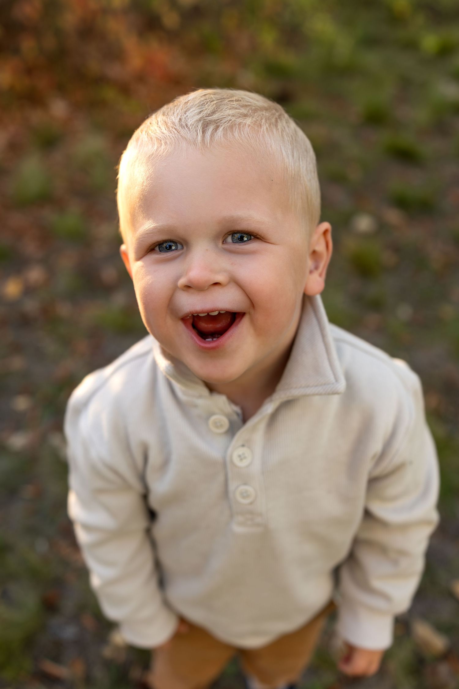 A portrait of a toddler boy smiling at the camera