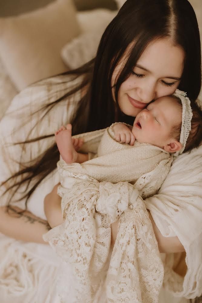 A mother holds her newborn daughter