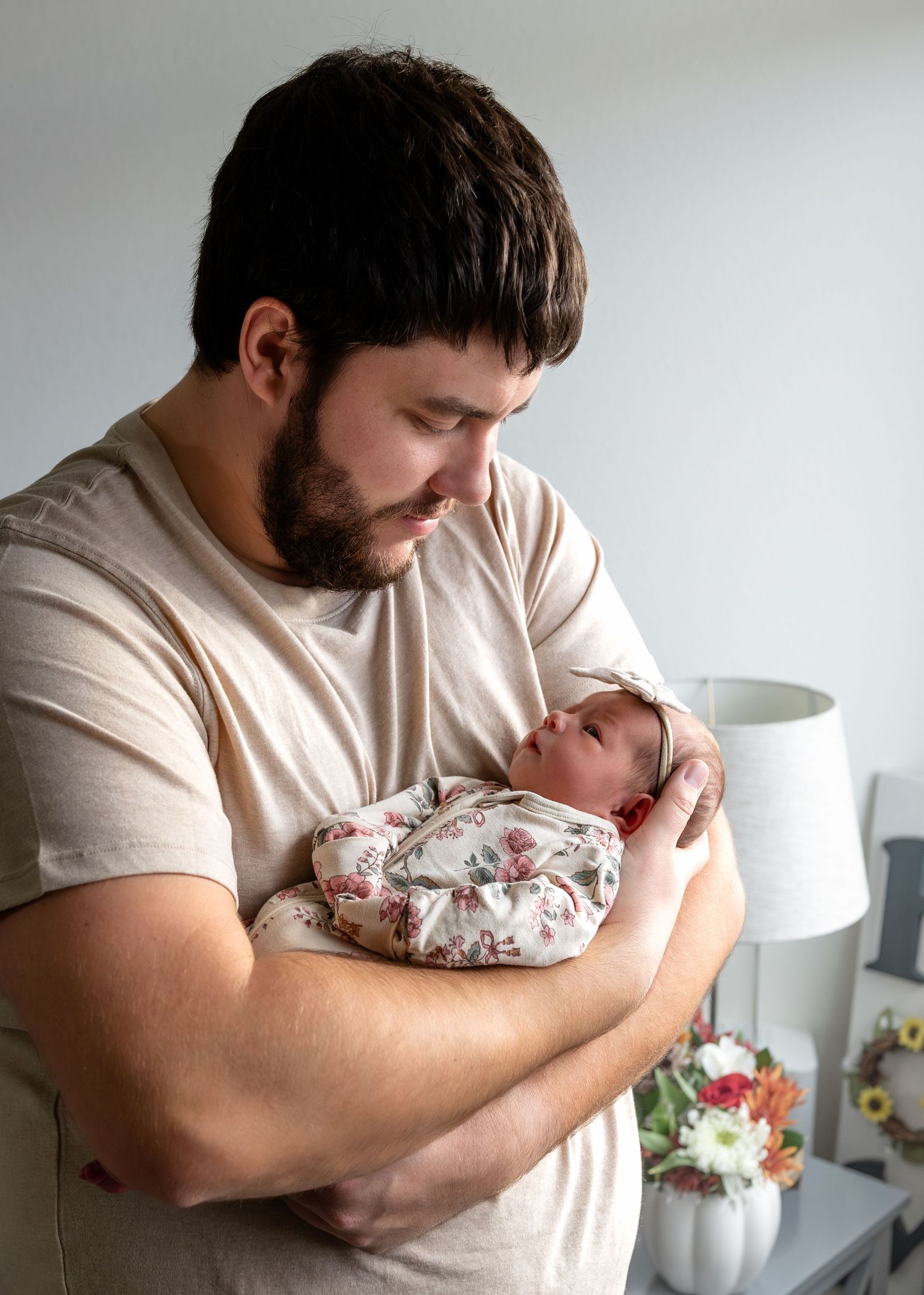 A father looks down at his newborn daughter