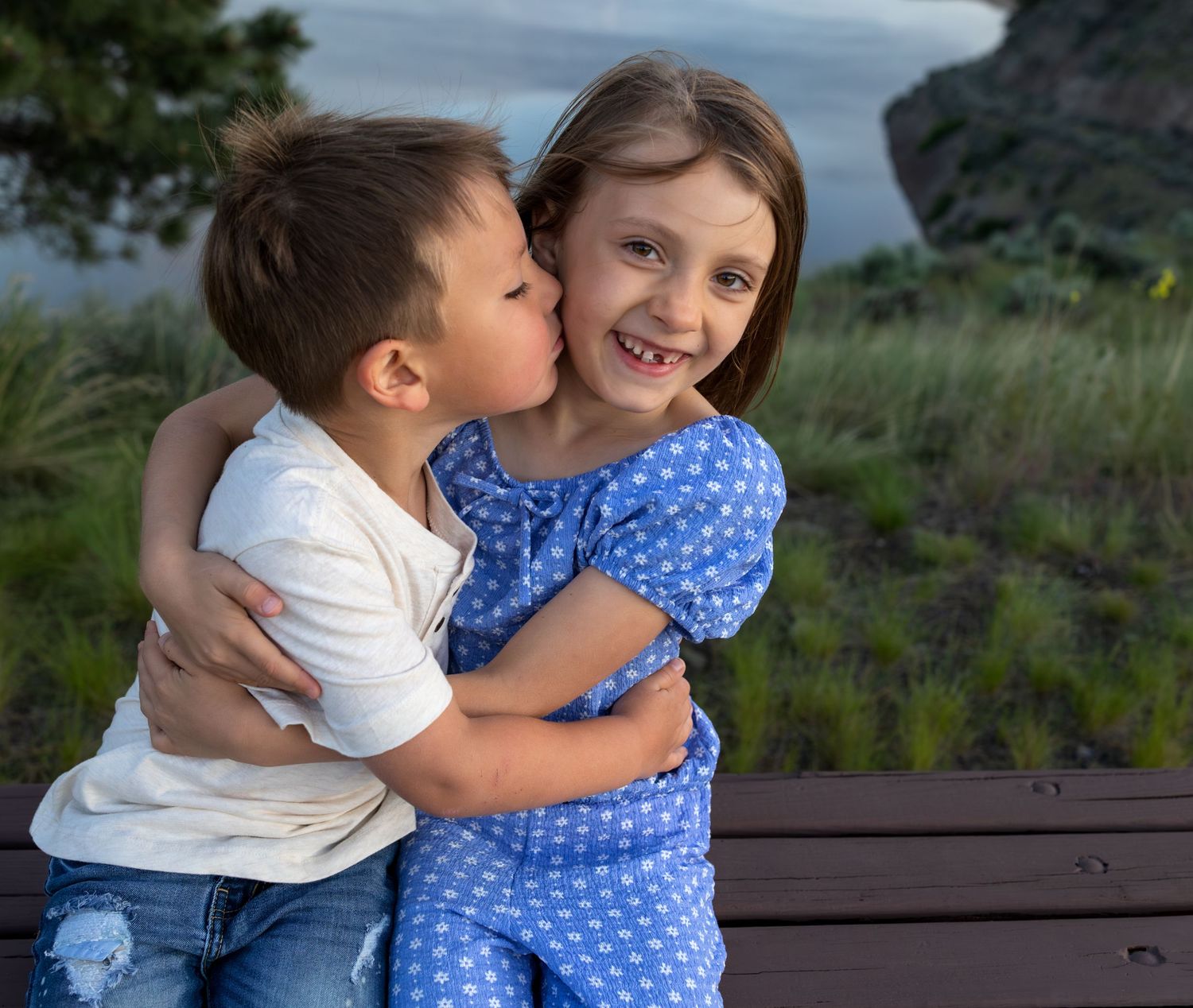 Family portrait with two kids playing and showing affection.