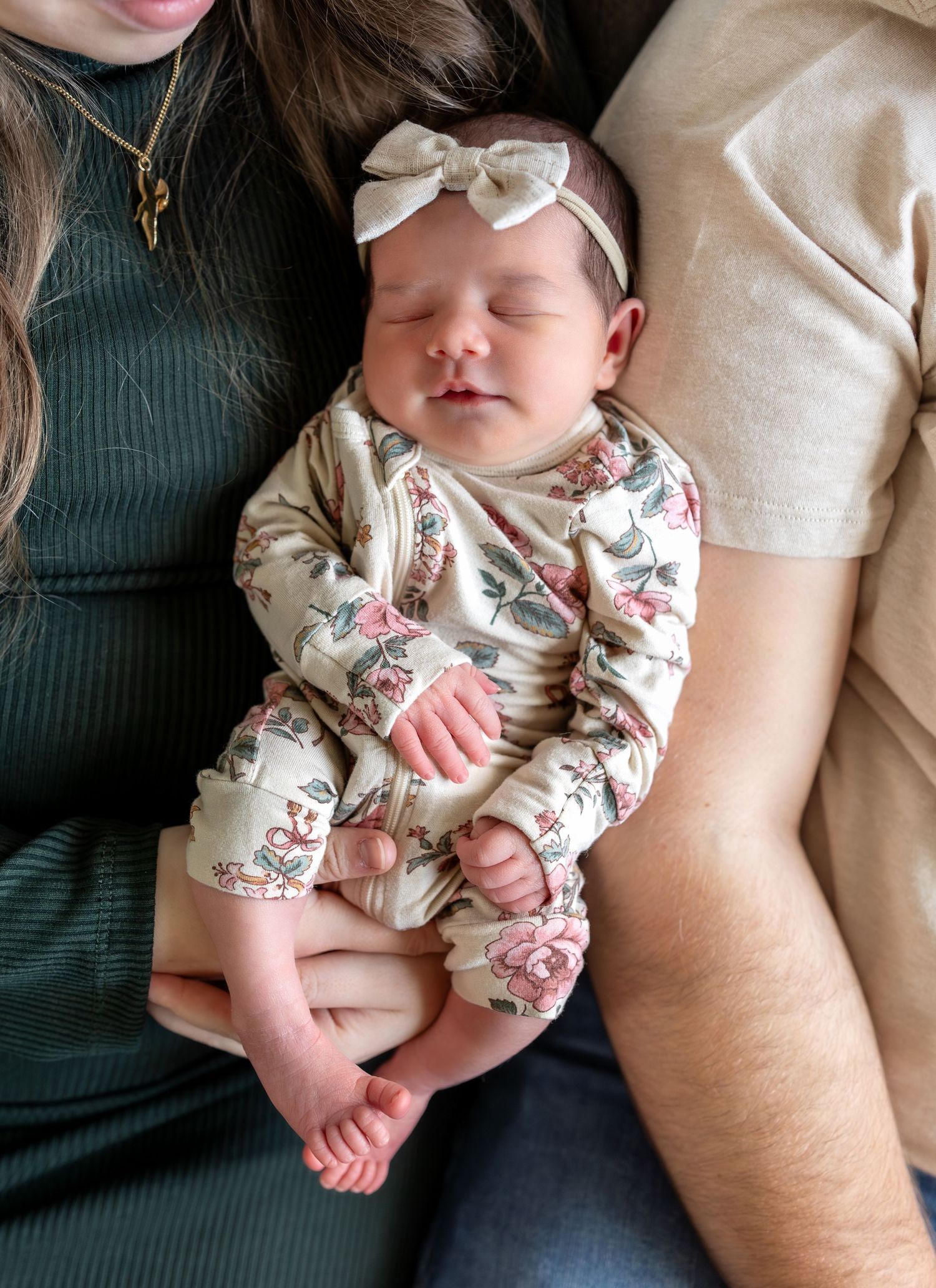 A close up image of a newborn girl smiling