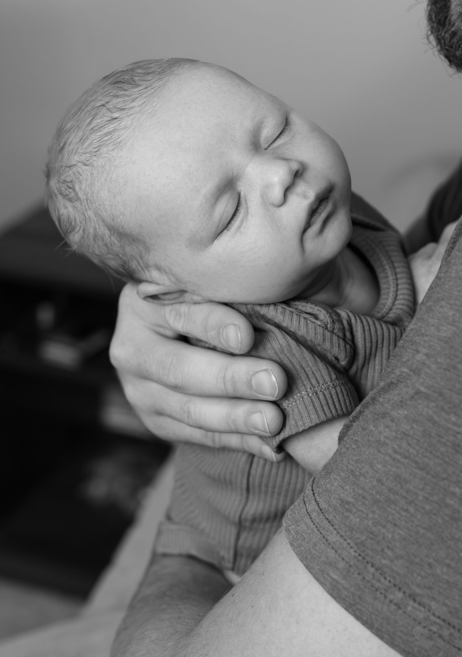 A close up image of a newborn baby boy sleeping.