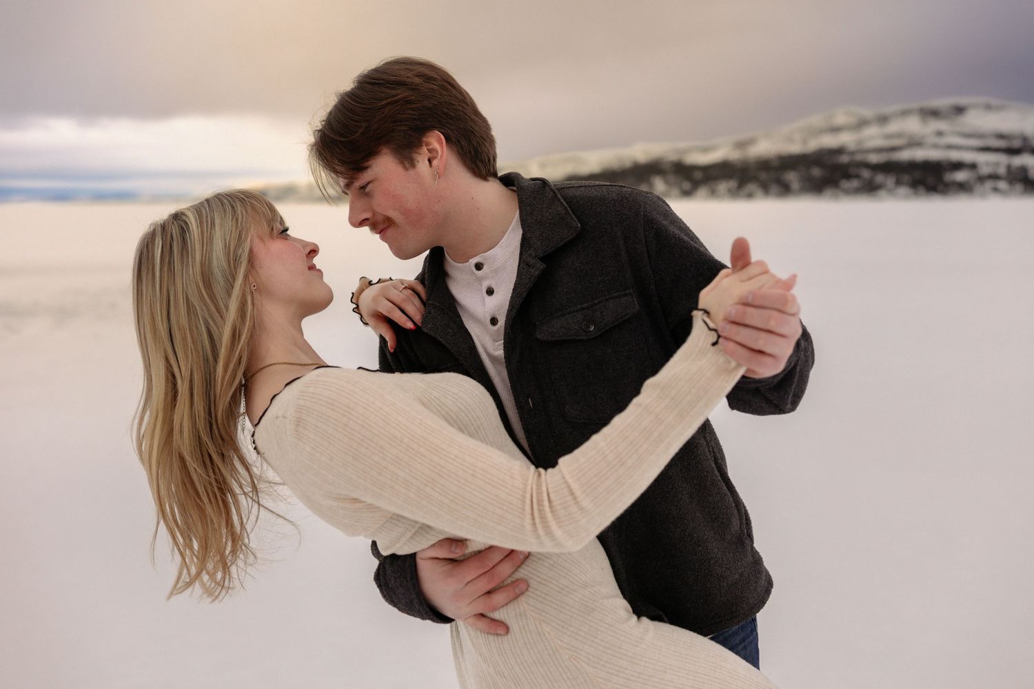 couples engagement photo with him dipping her and looking into her eyes.