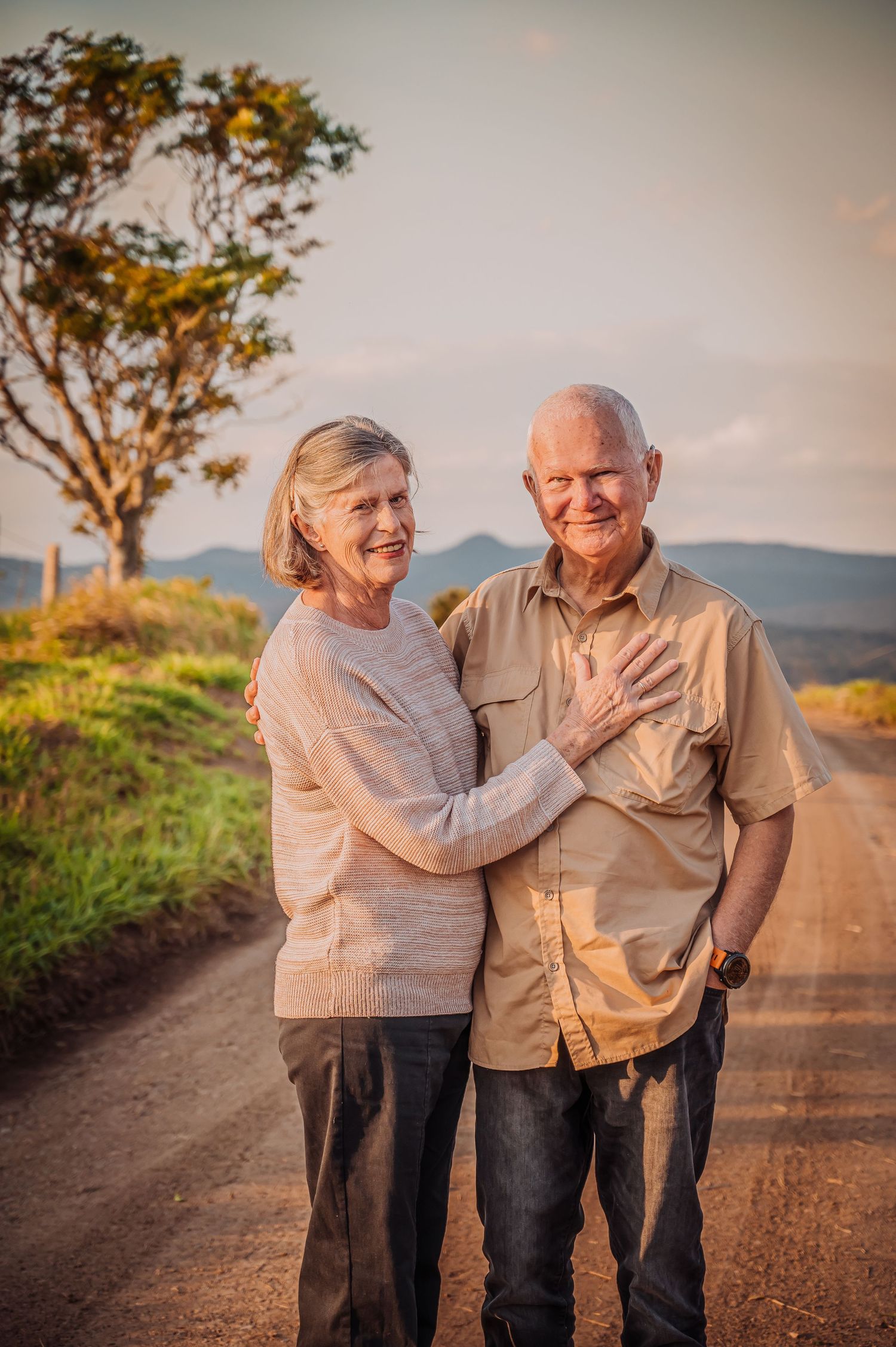 A heartwarming moment shared on a rural road at sunset.