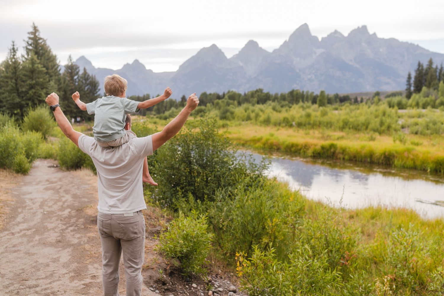 Dad and Son Cheering towards the mountains in excitement