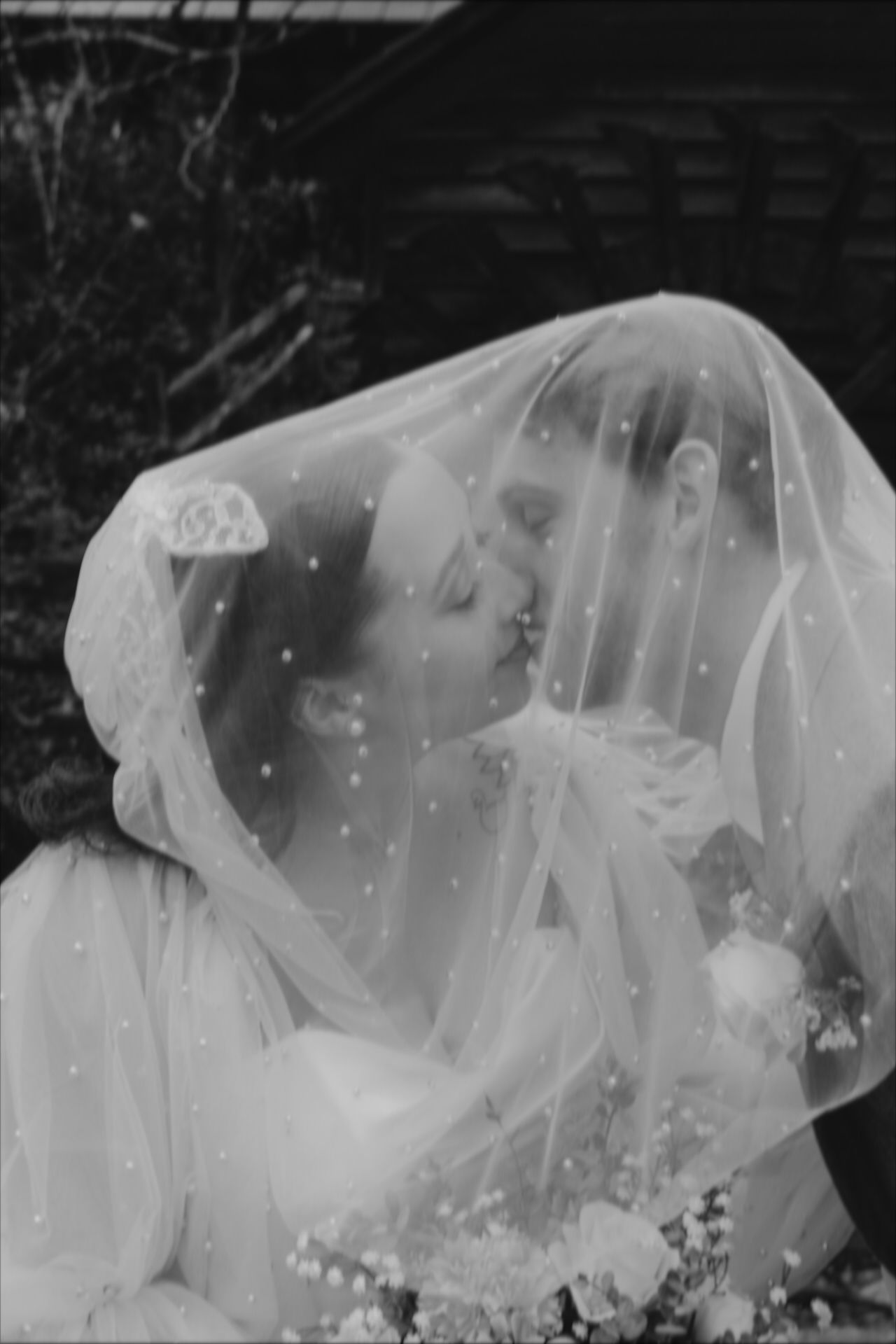 bride and groom, kissing underneath brides veil, black and white