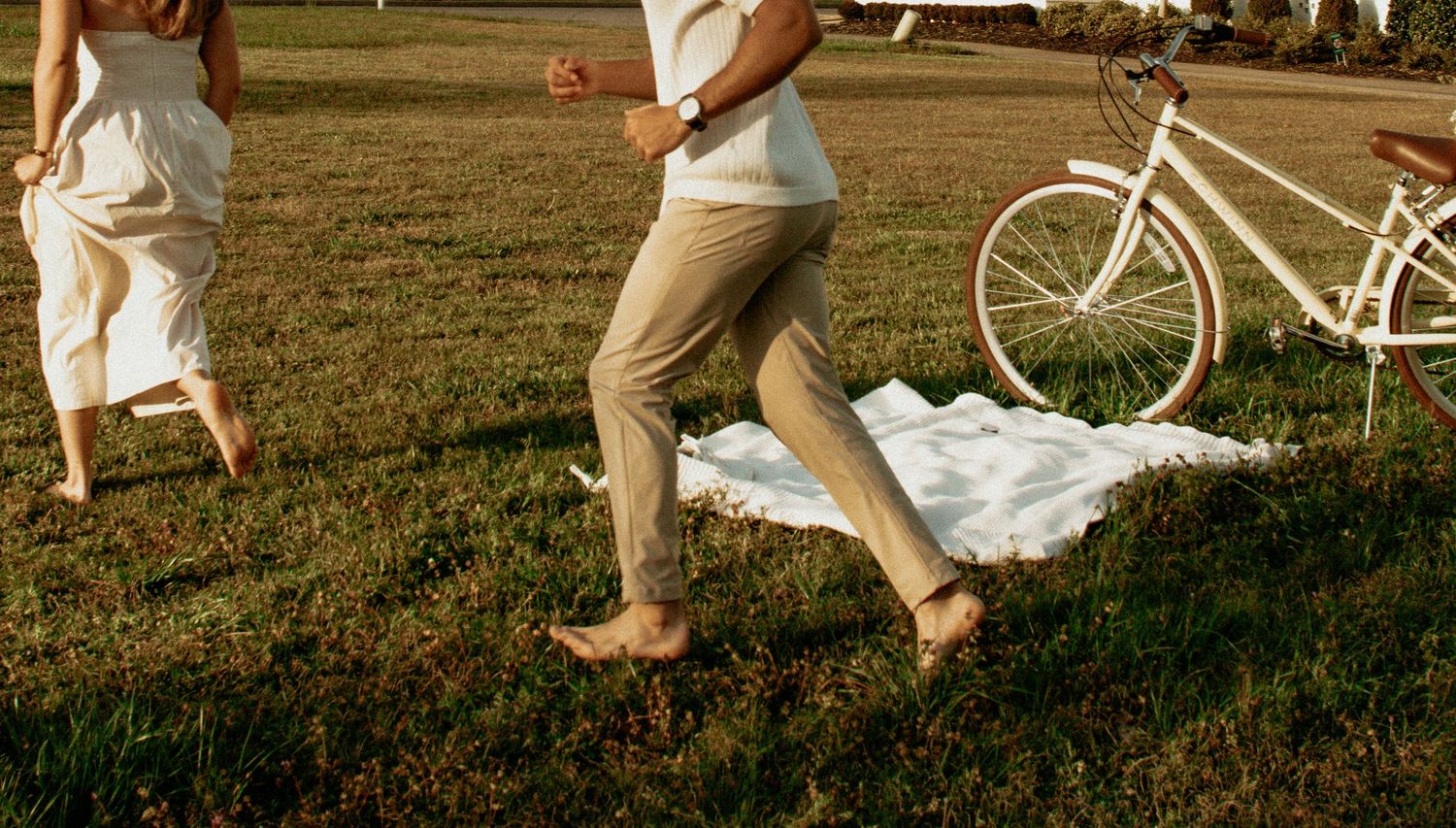 girl and boy, running through a field