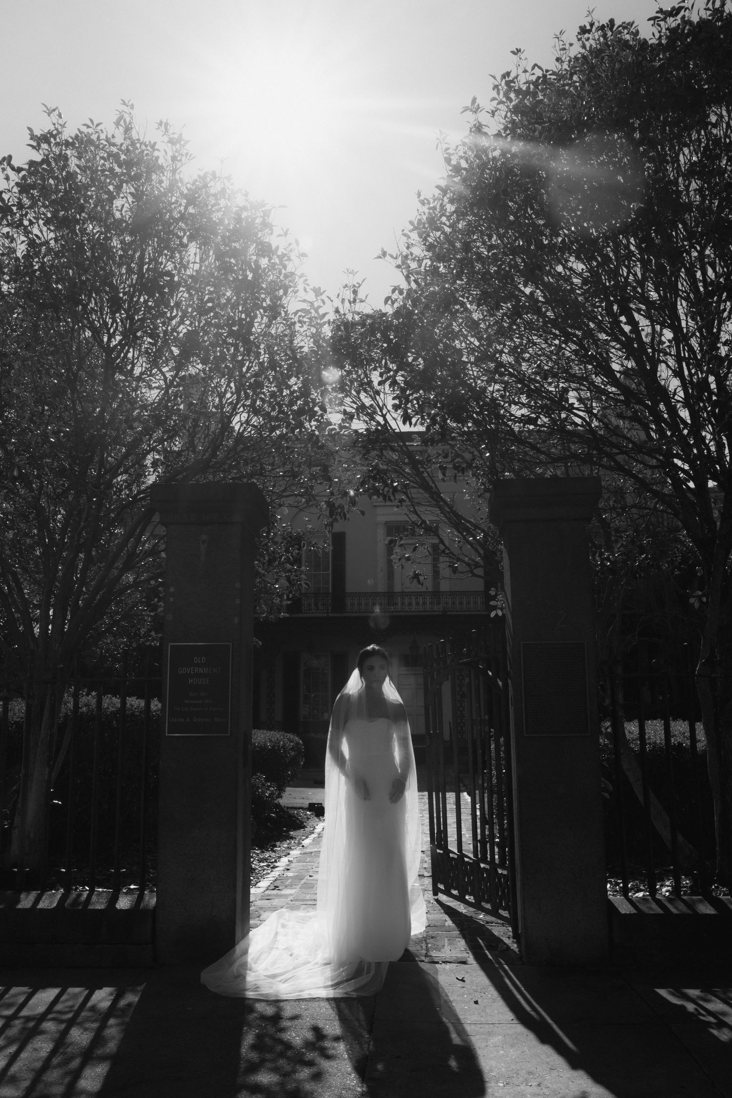 black and white, bride, standing in front of building, looking to the side