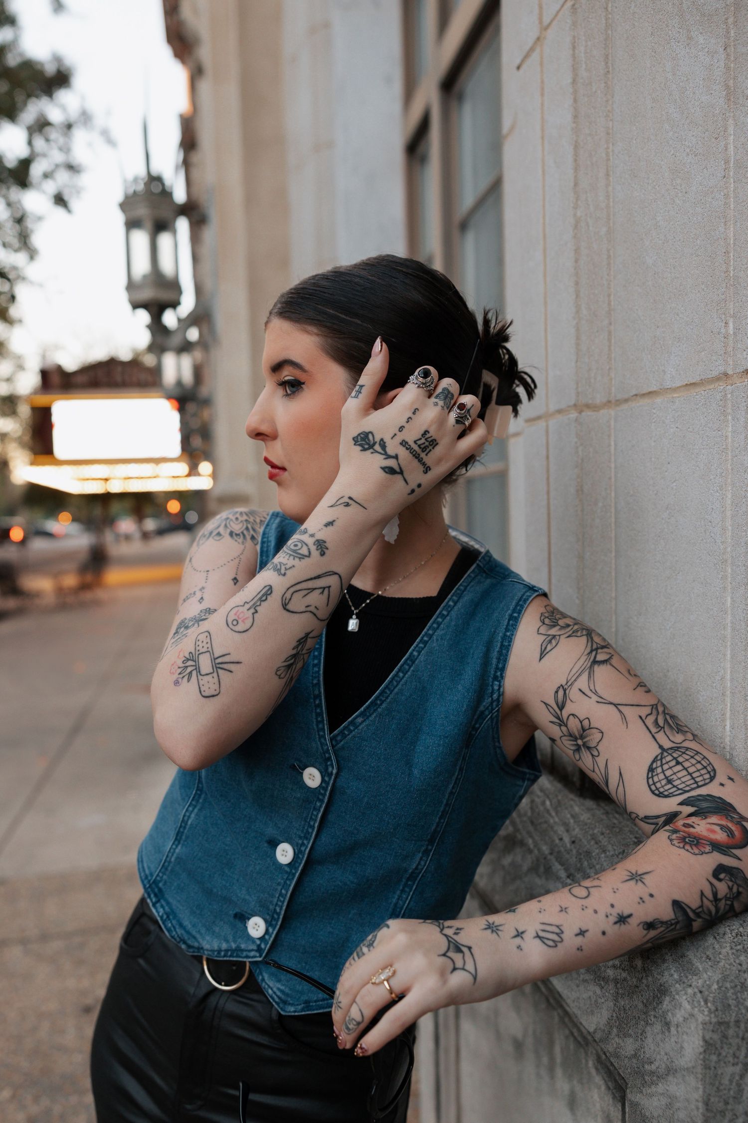 girl, hand brushing through hair, tattoos, side view, looking away