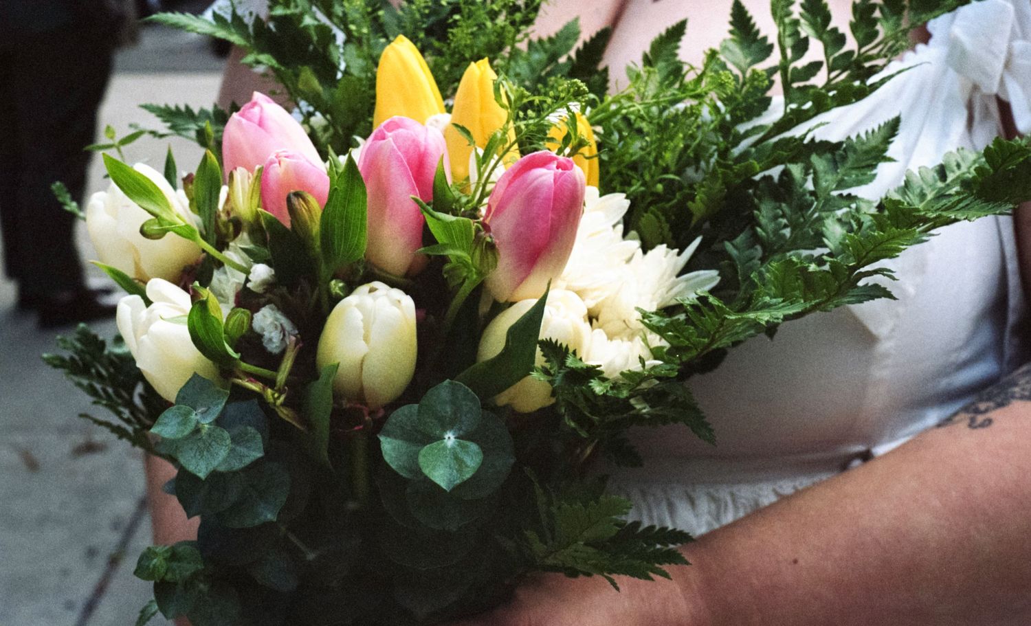 Candid film style photo of a bride's flowers