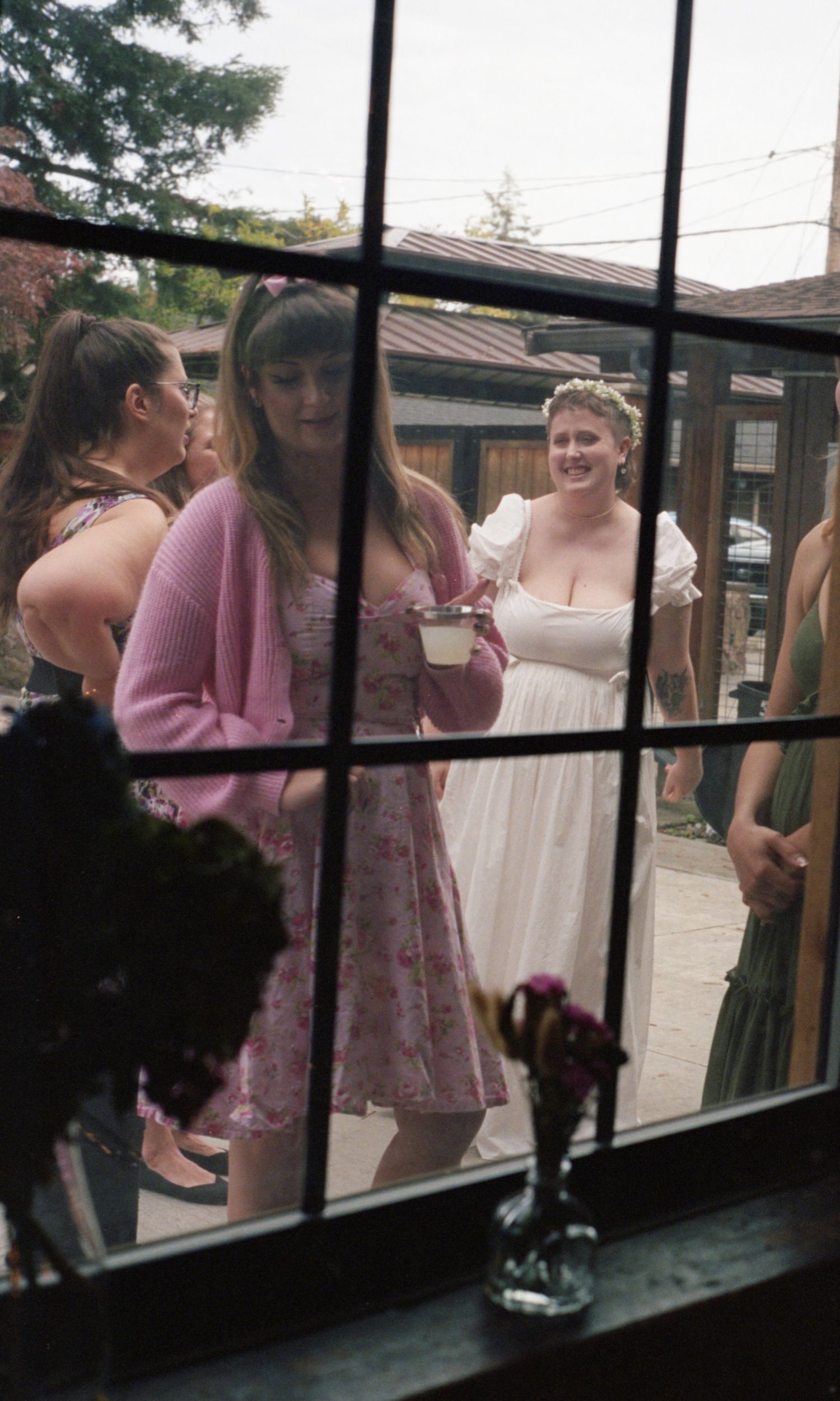 Candid film style photo of a bride shot through a window