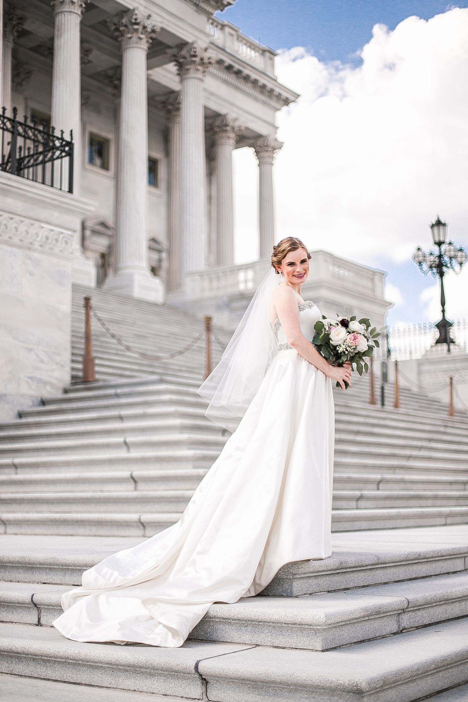 Elegant bridal portrait series captured on white marble steps of a grand neoclassical building with towering columns.