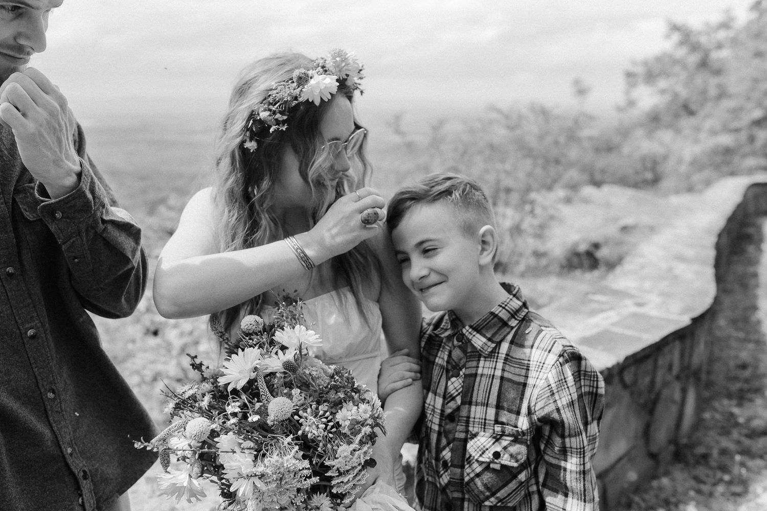 Black and white photographs showing romantic couple moments in outdoor countryside settings during engagement or wedding session.
